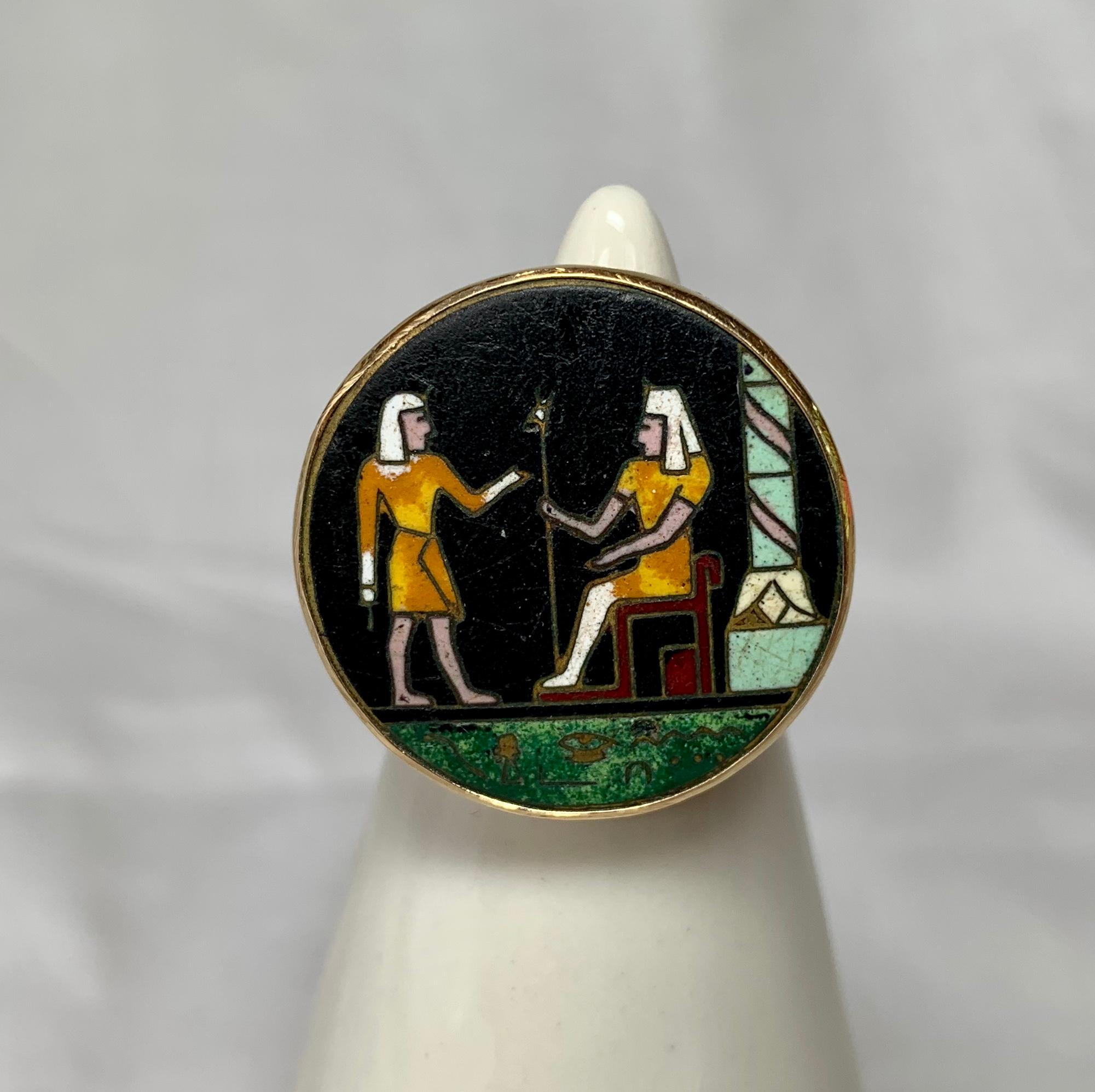 A rare Art Deco Egyptian Revival masterpiece.  The ring with a central hardstone Pietra Dura image of two Pharoahs with a column on a green ground with a black background.  A masterpiece of Pietra Dura work and very rare to find in the Egyptian