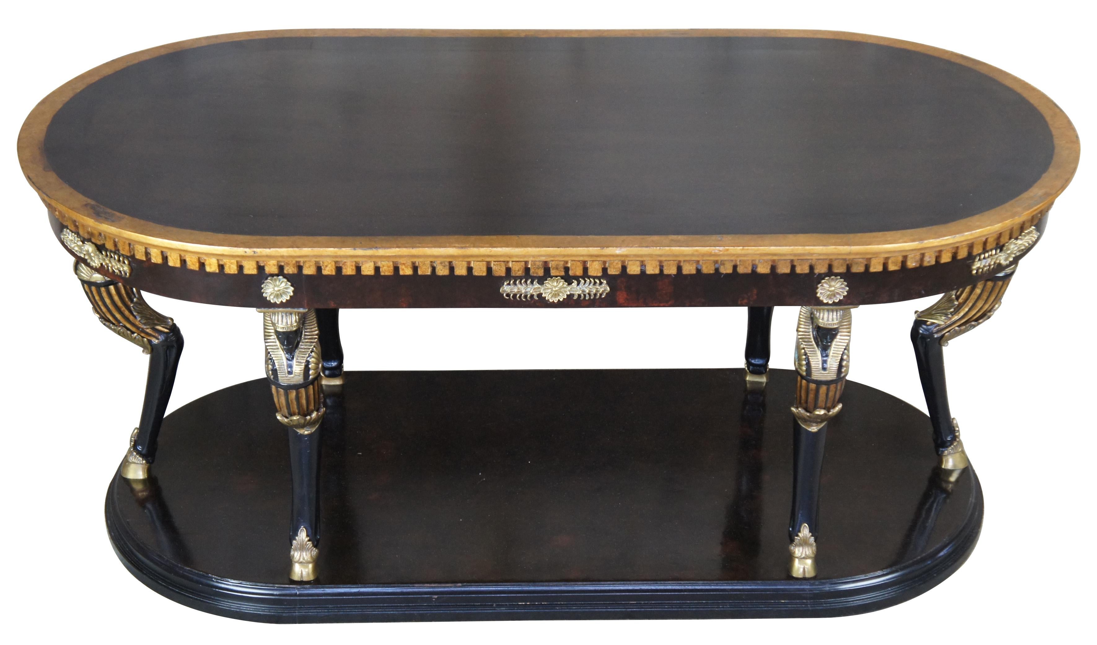 Egyptian Revival Regency oval coffee table neoclassical figural caryatid vintage

Neoclassical or Regency style table. Finished in a dark burl wood with black top. Features architectural design along the apron of the table and brass medallions.