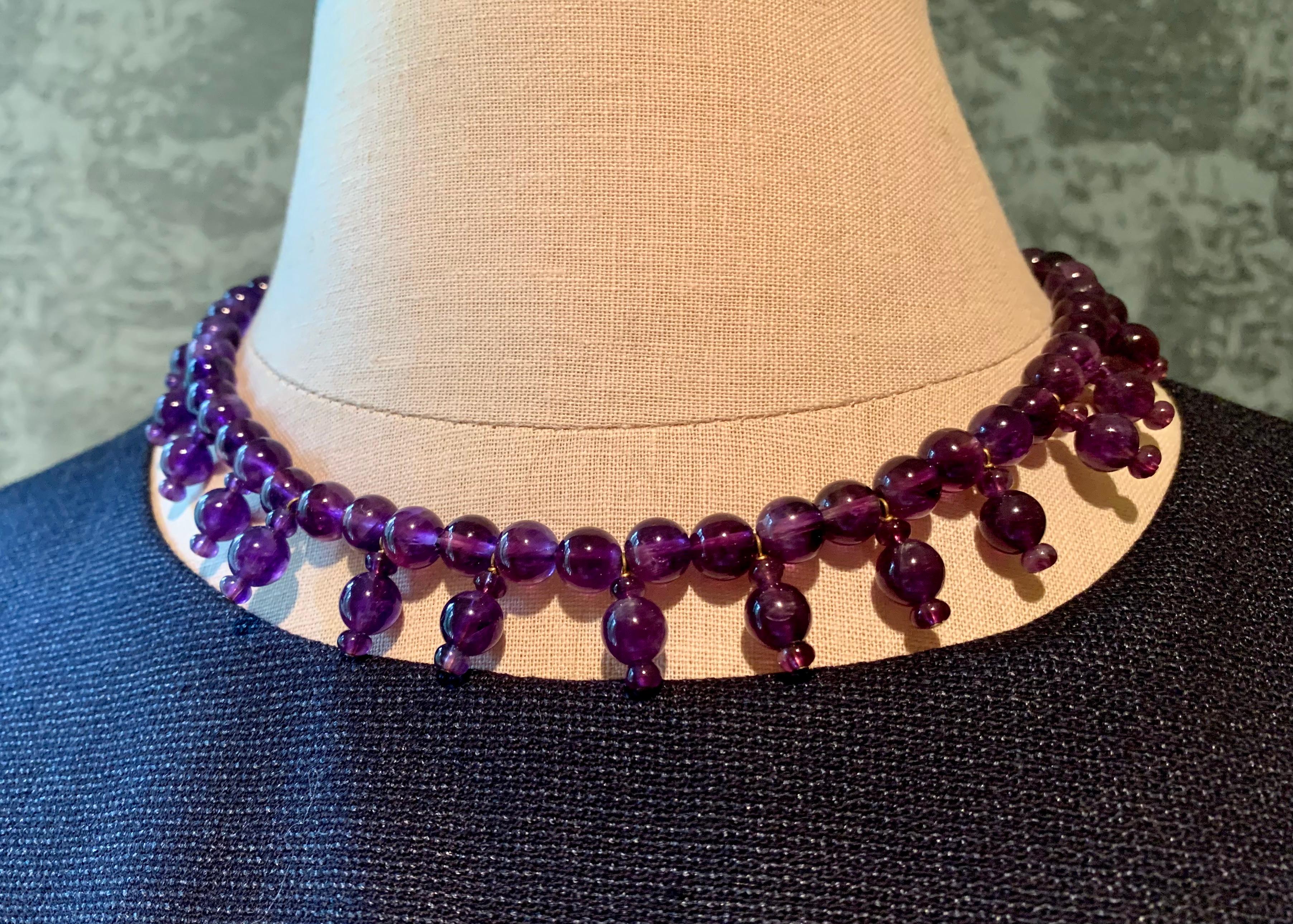 Egyptian Revival amethyst bead necklace with 14K gold bamboo motif clasp.
The design of this necklace is based on Egyptian New Kingdom necklaces called Poppy Bead Necklaces, for their resemblance to the bud of the Poppy flower. Poppies were popular