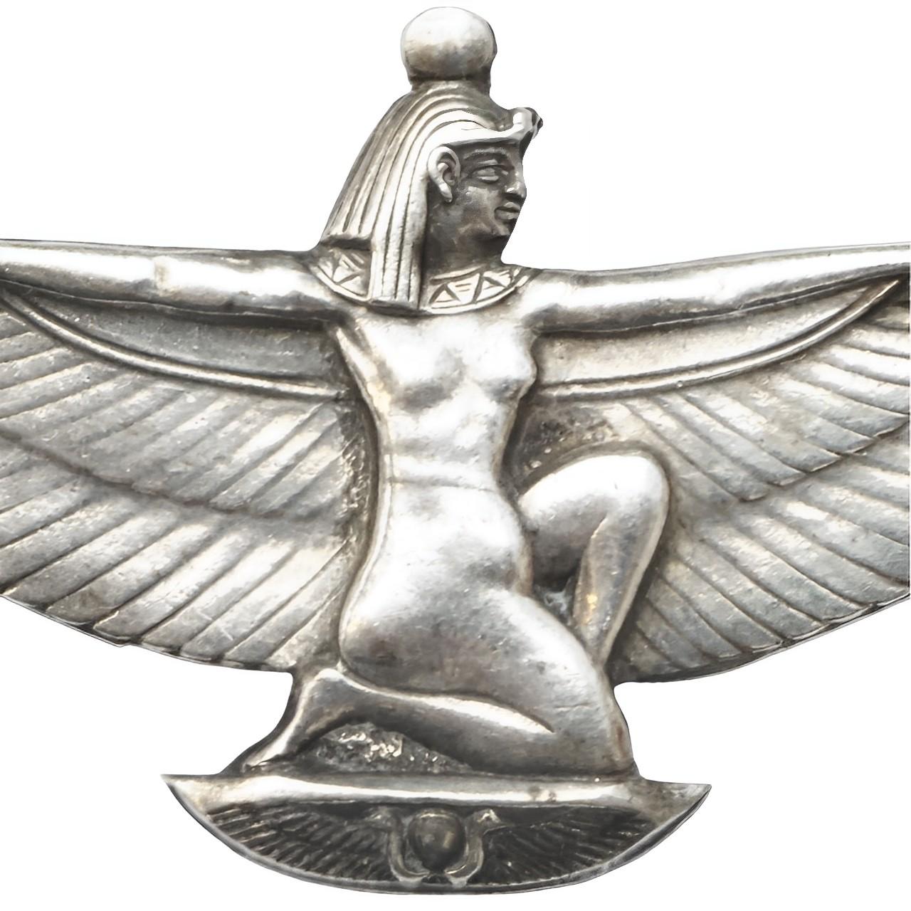 Wonderful Egyptian Revival silver Isis goddess brooch. Measuring length 5.1 cm / 2 inches by maximum width 2.7 cm / 1 inch. The pin is bent but works well. The brooch tests for silver. We have given it a light clean.

This beautiful silver Egyptian