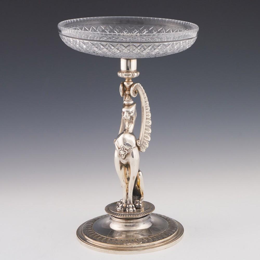 Heading : Egyptian revival silver plate and glass centrepiece
Date : c1930
Period : Interware
Origin : Probably Germany
Decoration : Scalloped edged bowl with and graduated diamond cutting. Silver plating in the form of a winged cat, possibly a