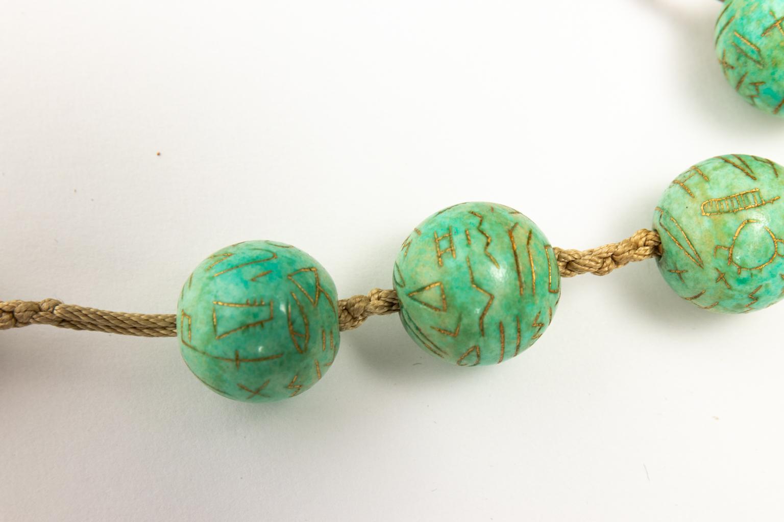 Circa 1918 Egyptian Revival style Turquoise colored Faience pendant with a knotted bead chain and gold detail. This piece also has a pendant which is detachable to be worn as a standalone piece.
