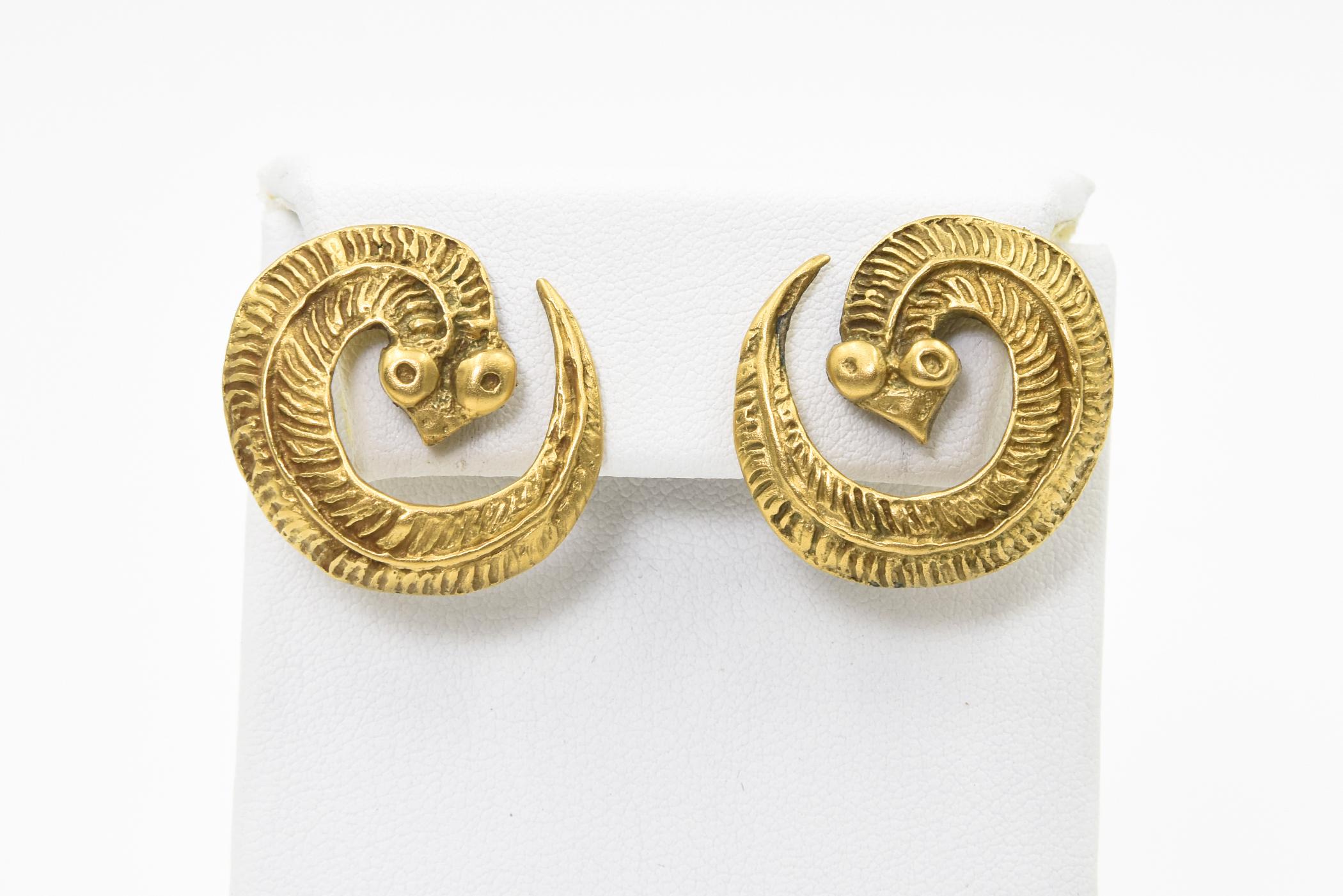 Vintage Metropolitan Museum of Art snake brass post earrings  - so you must have pierced ears.  They are marked MMA and have what look like Egyptian characters.