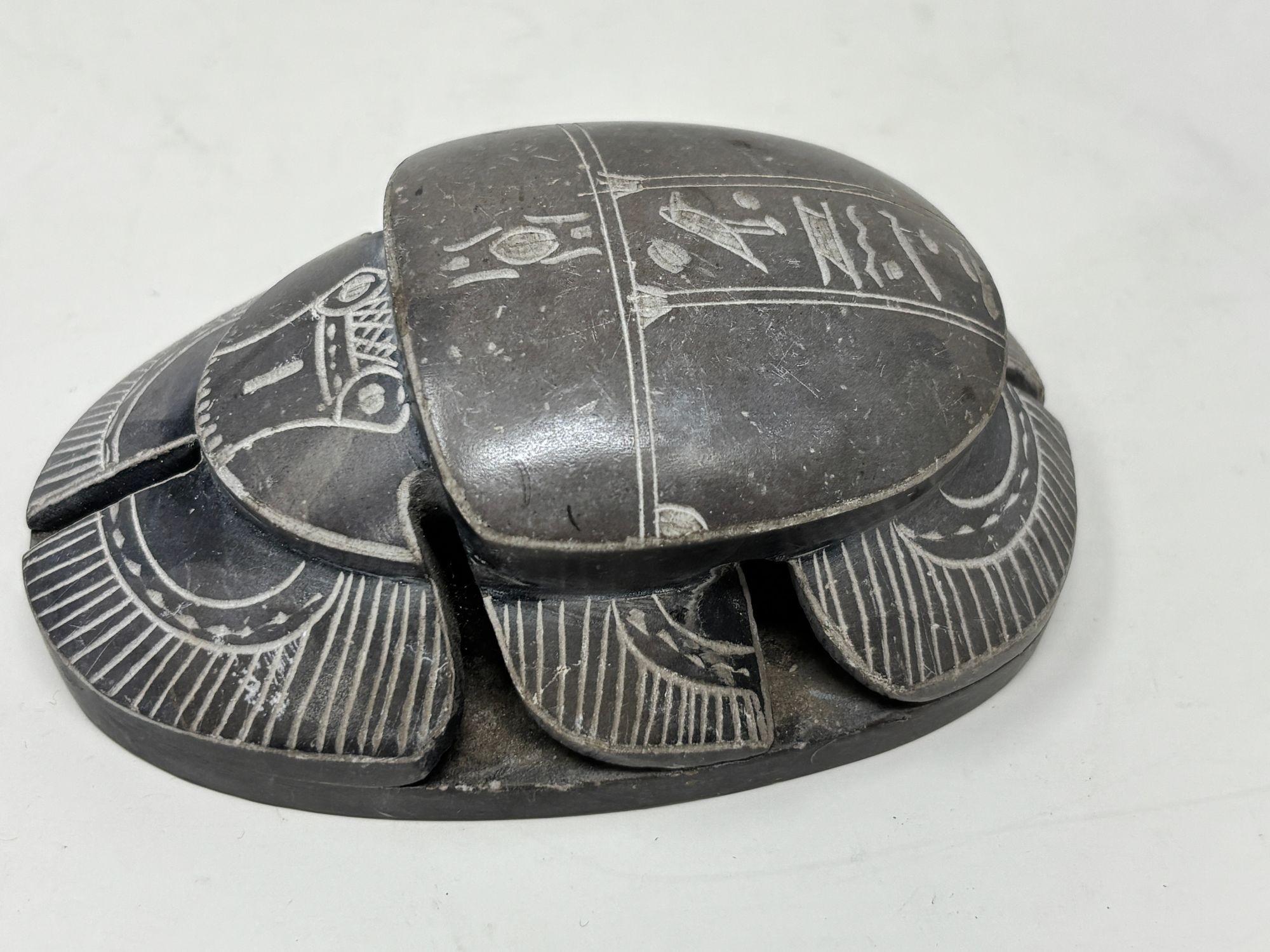 Egyptian Scarab Stone Beetle Figurine after the Egyptian Museum antiquities.
A unique and beautiful addition to any Egyptian Art Deco collection.
This vintage gray stone Egyptian scarab beetle sculpture figurine could be used as a paperweight or