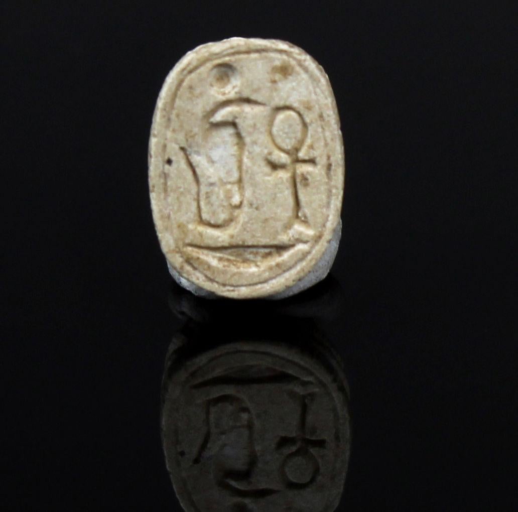 ITEM: Scarab with Uraeus, Ankh and neb basket (Amun trigram)
MATERIAL: Steatite
CULTURE: Egyptian
PERIOD: New Kingdom, 1550 – 1070 B.C
DIMENSIONS: 12 mm x 8 mm
CONDITION: Good condition
PROVENANCE: Ex American egyptologist collection, active in the