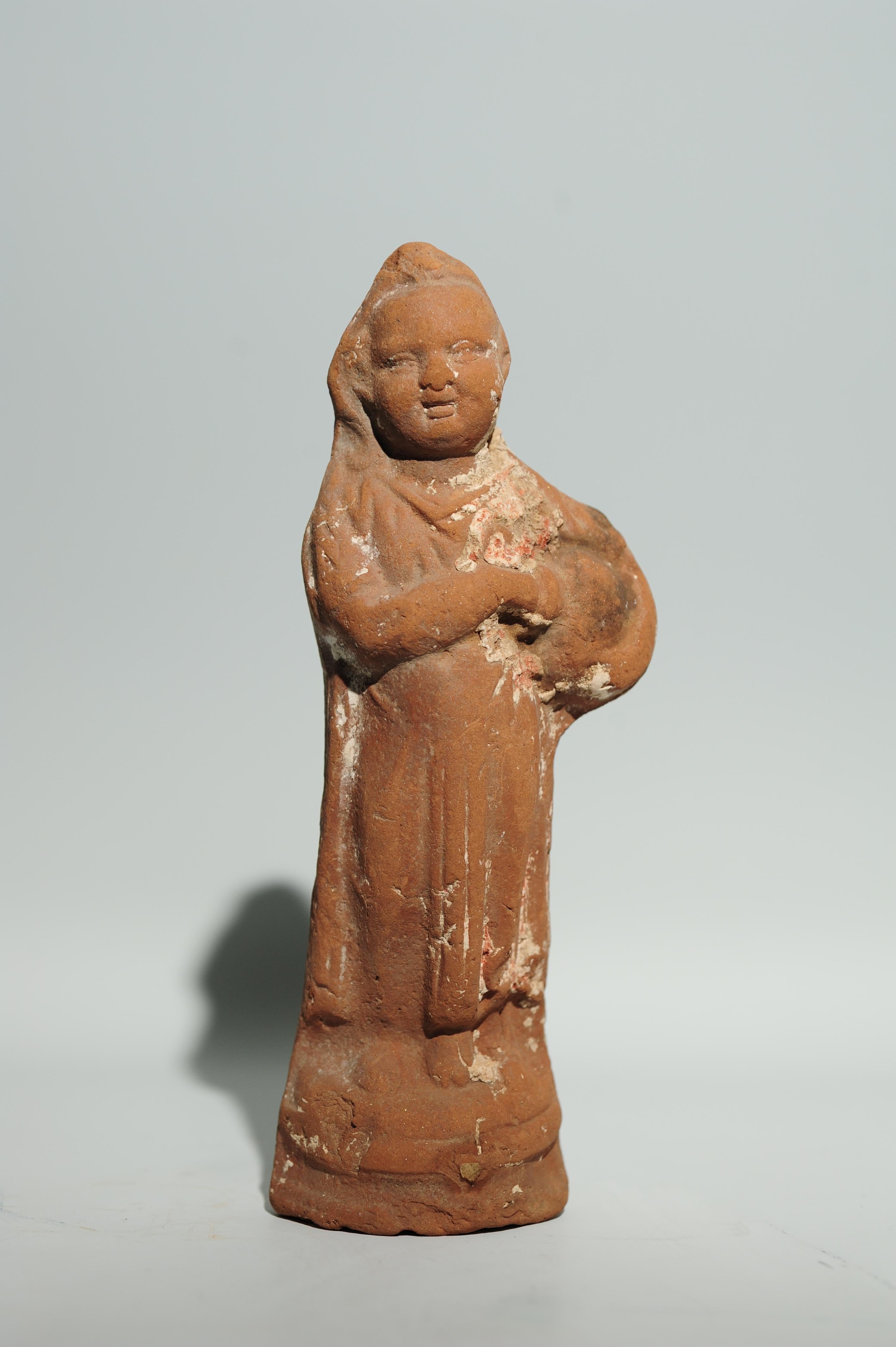 Terracotta statuette of Harpocrates with pot

Molded. The standing Harpocrates is holding a tilted clay pot with his left arm while his right hand is taking effect as if he wants to disperse its content; probably seeds. These terracotta clay figures