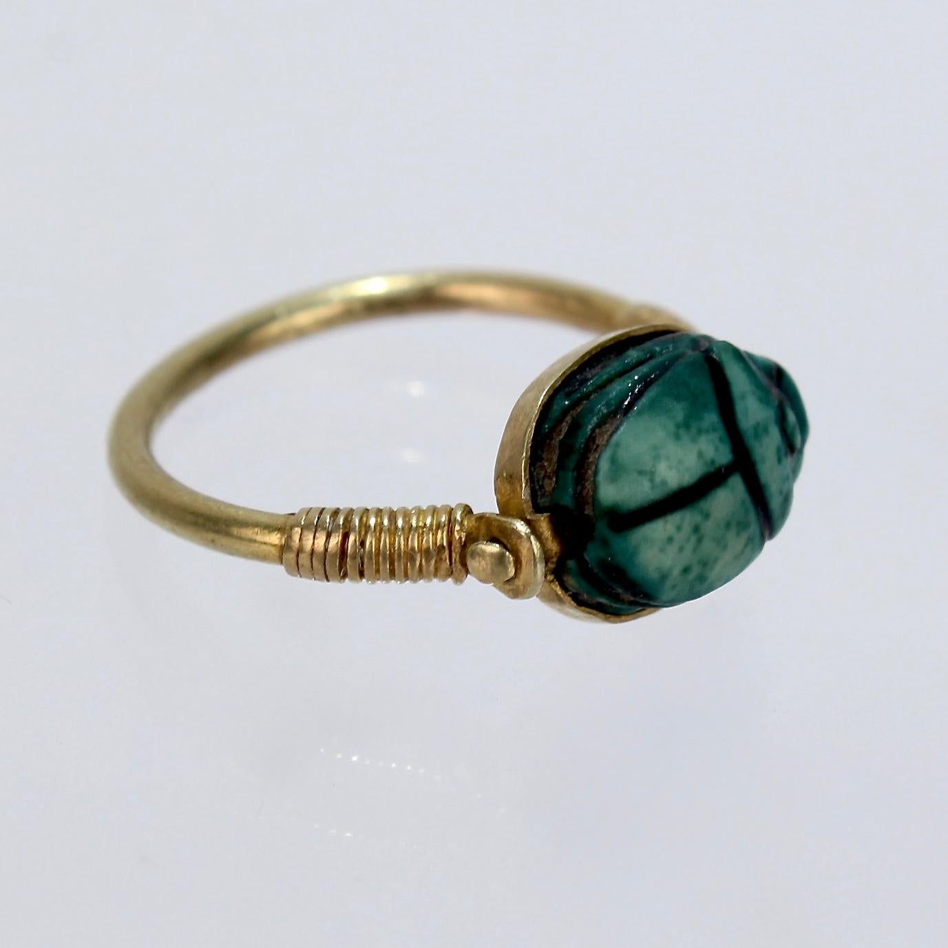 A rare antique Egyptian steatite scarab and gold finger ring.

It is accompanyied by a note from the shop of Mohammed Mohasseb & Son from Luxor, Egypt. 

The note identifies the ring as 18th Dynasty (about 1500 BCE), bearing the name of Amen-Ra -