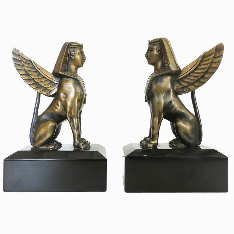 1920s inspired sculpture of sphinx solid bronze on absolute black marble.

Could be used as bookends or figurine. Sold in pairs. 8.5