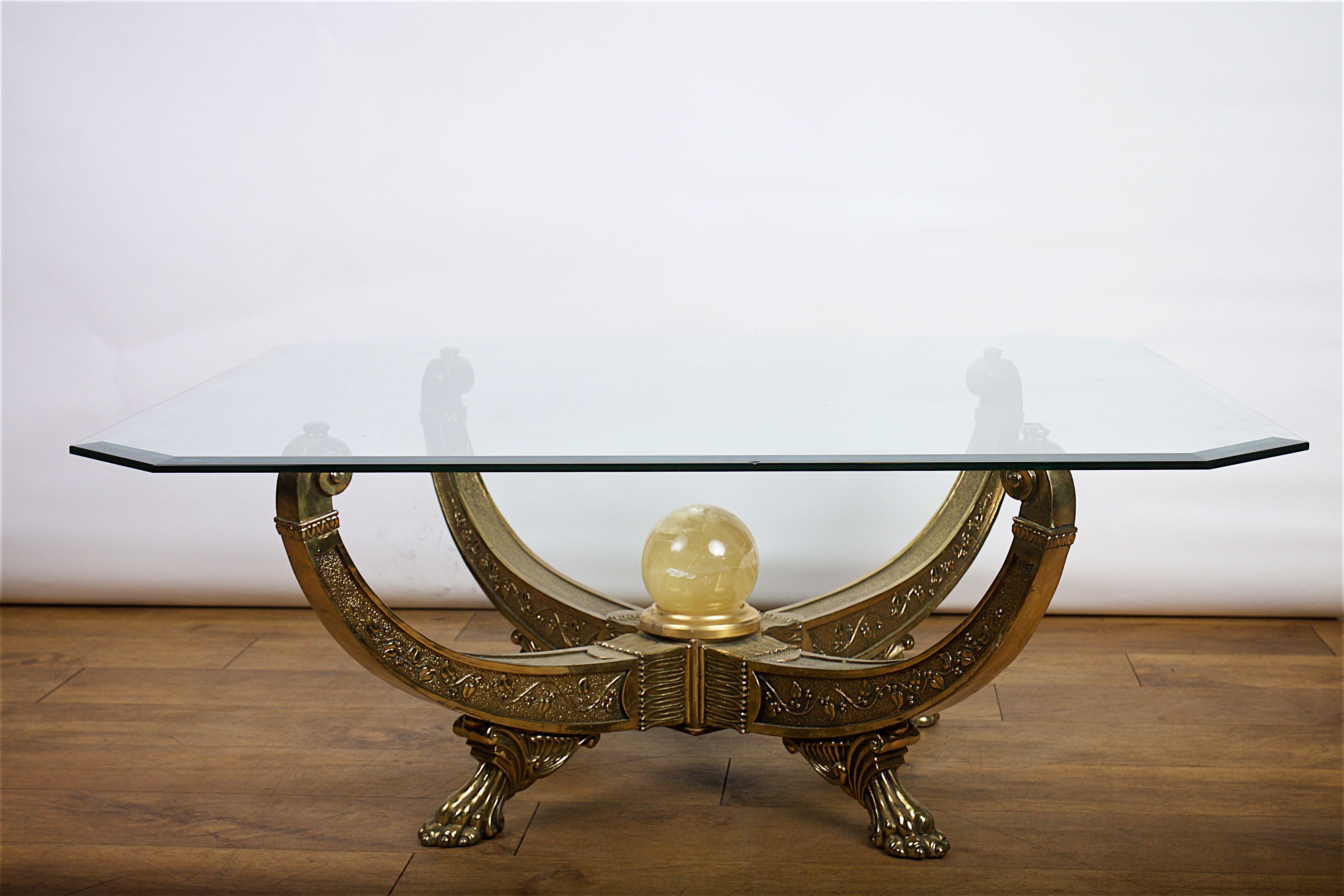 Mid-20th century brass Egyptian style glass topped coffee table.
