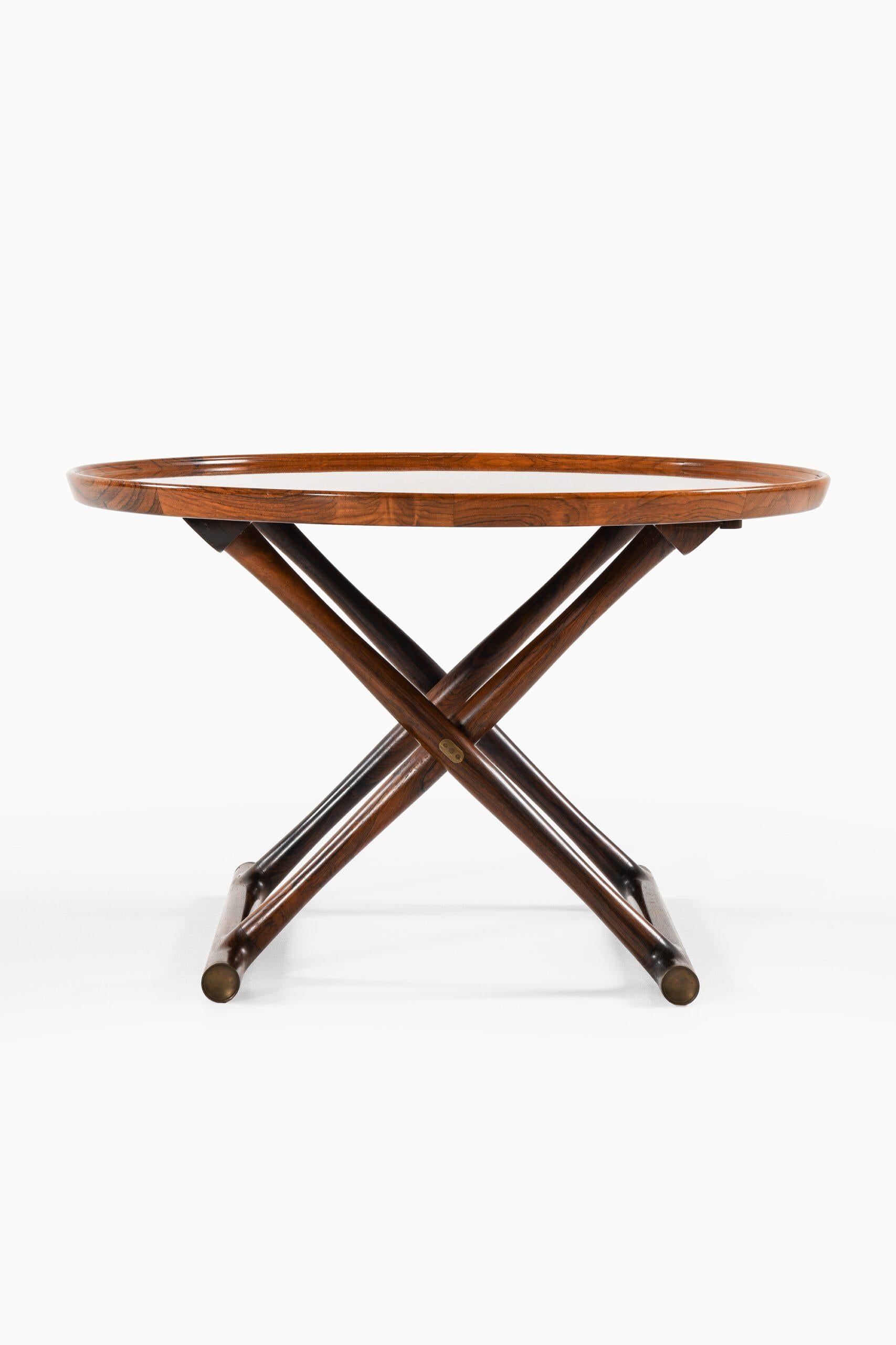 'Egyptian Table' in Rosewood and Brass by Mogens Lassen, 1935

Additional Information:
Material: Rosewood and Brass
Style: Scandinavian Modern
Coffee Table
Produced by Cabinetmaker A.J. Iversen in Denmark
Dimensions: 
(W x D x H): 85 x 85 x 52,5