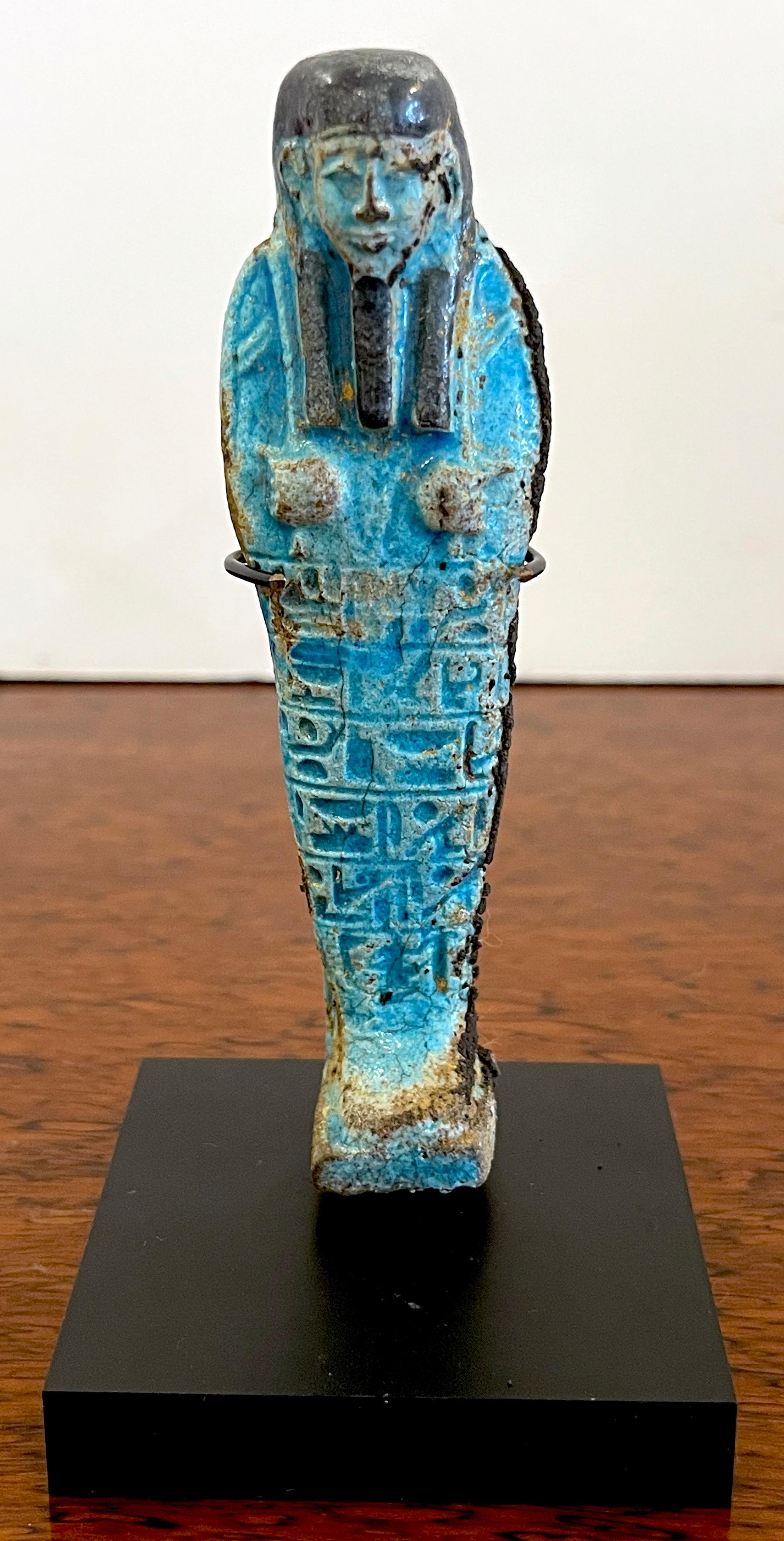 Egyptian Turquoise Faience Shabti, Museum Mounted 
Egypt, 300-600 BC

Dating back to 300-600 BC, this exceptional Egyptian turquoise faience shabti is a finely executed and exquisite representation of a funerary figure. Museum mounted for display