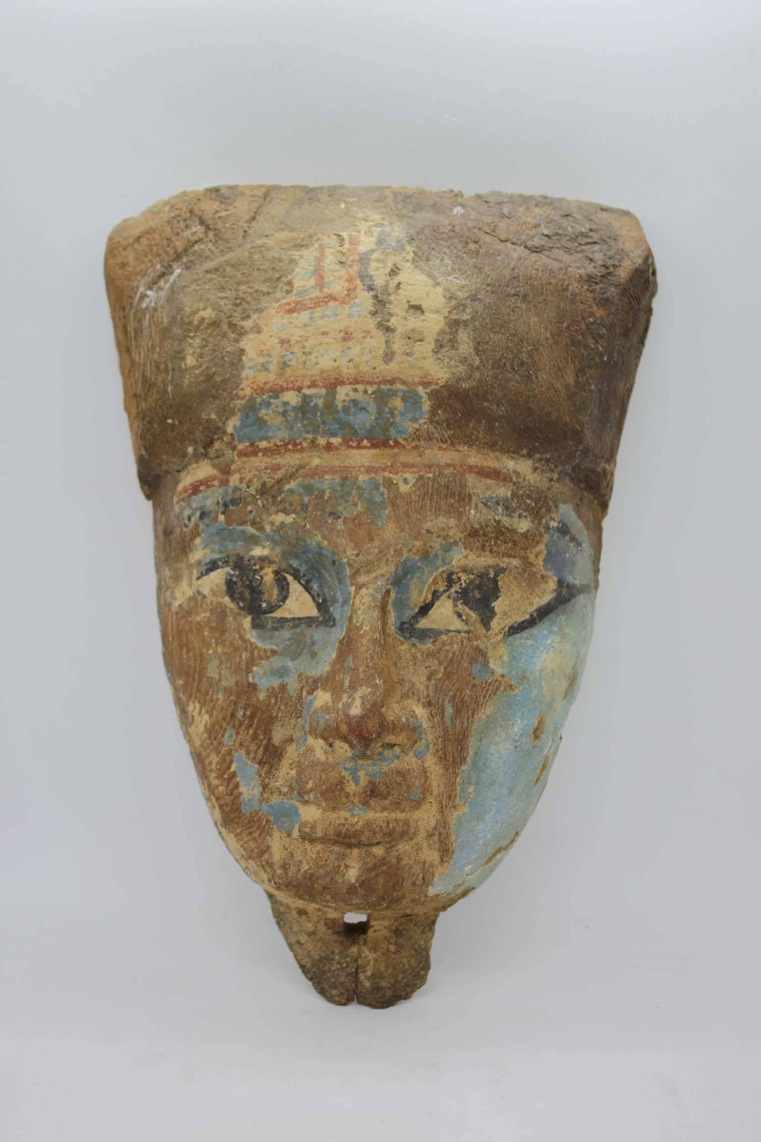 Authentic Egyptian Sarcophagus mask with painted decoration, Ptolemaic period (323 - 30 BC.)
Good condition. 
 Dimensions: Height 30cm, width 21cm, depth 5cm.