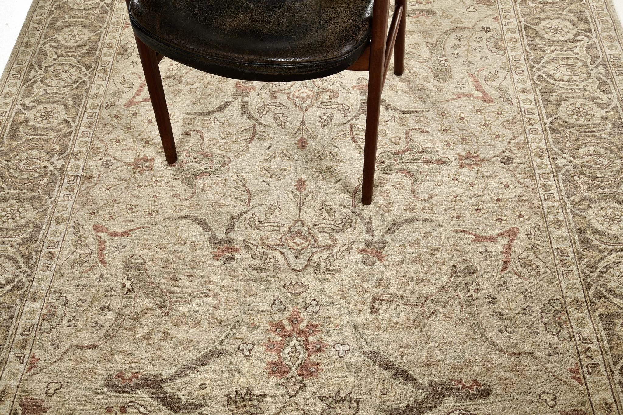 A sophisticated revival of Zeigler Rug that features a large scale design on an attractive beige field with the main border in ash gray symmetrical medallions. The carpet has an overall muted tones of natural colours. Perfect for a minimalist to