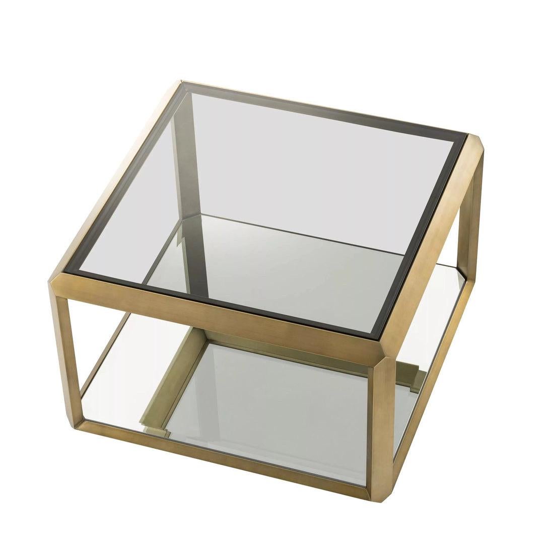 We are very pleased to offer a pair of brand-new side table by Eichholtz Furniture, based in the Netherlands. Evoke the seductive style of the seventies with the decadent Callum side tables. Their brushed brass frame with beveled rims surrounds the