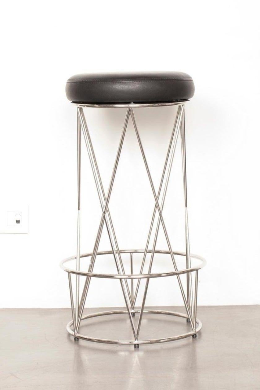 From the Eiffel line, this stool combines aesthetics and comfort, with a crossed polished stainless steel base and a soft, full-grain leather seat 
Polished stainless steel structure, Upholstered leather seat.