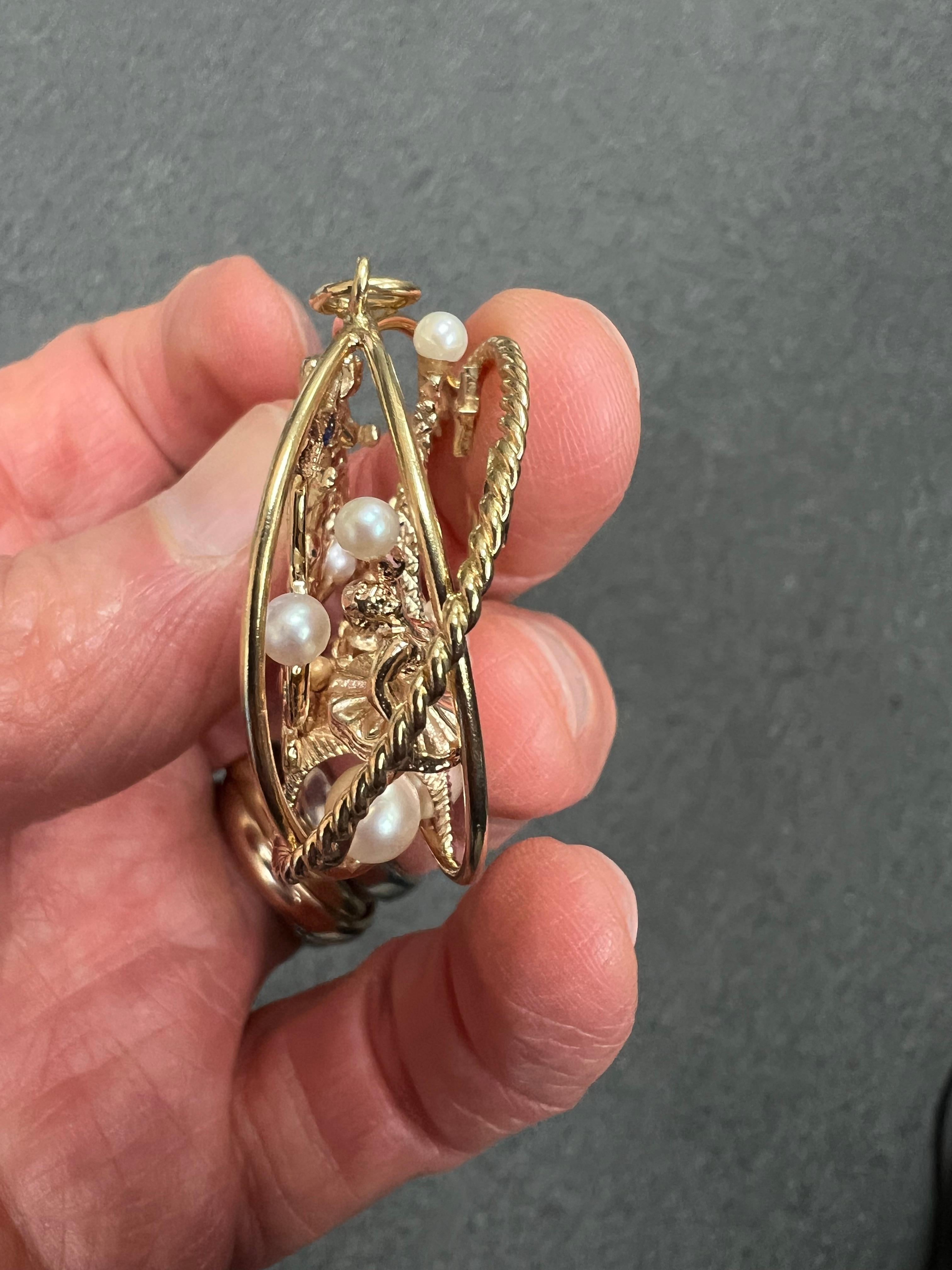 Eiffel Tower cultured pearls ruby and sapphire yellow gold charm pendant circa 1950.  *

ABOUT THIS ITEM:  P-DJ818E.  Scroll down for specifications.  This charm seems to have been inspired by the popular MGM musical, An American in Paris. It