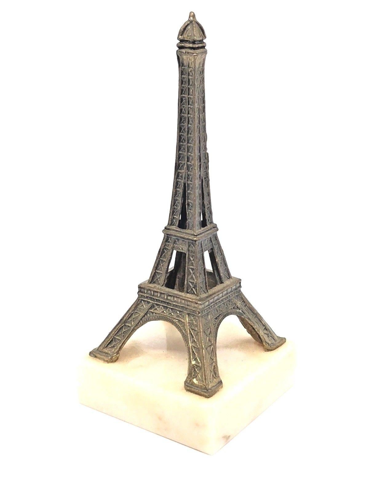 A decorative Eiffel Tower souvenir building sculpture. Some wear with a nice patina, but this is old-age. Made of metal and a marble base. This item was bought as a souvenir in Paris, France and was made probably in the 1930s.