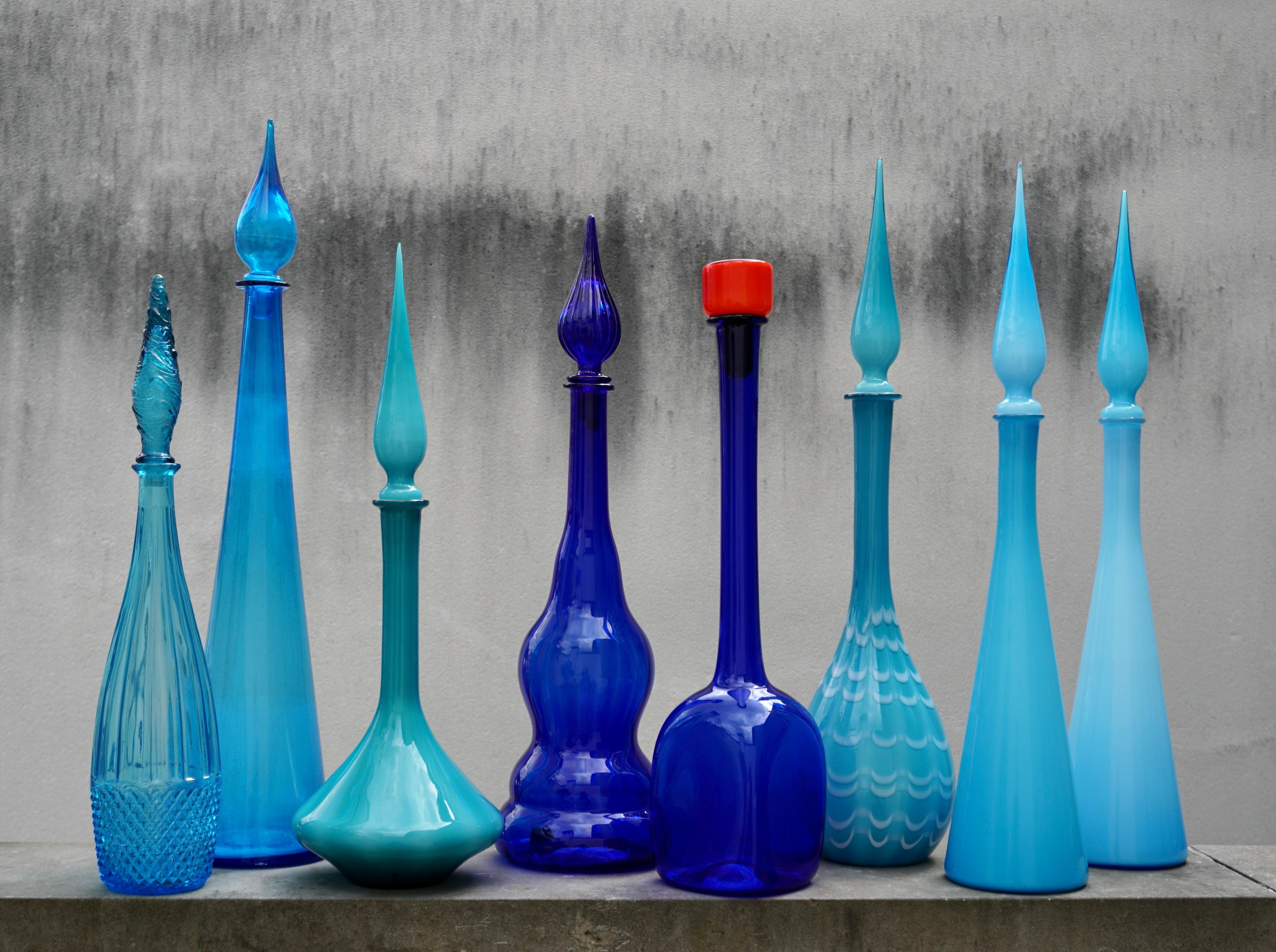 Colorful set of 8 glass decanters with geometric design, made by one of the many glass manufacturers based in the region of Empoli, Italy.  Has 