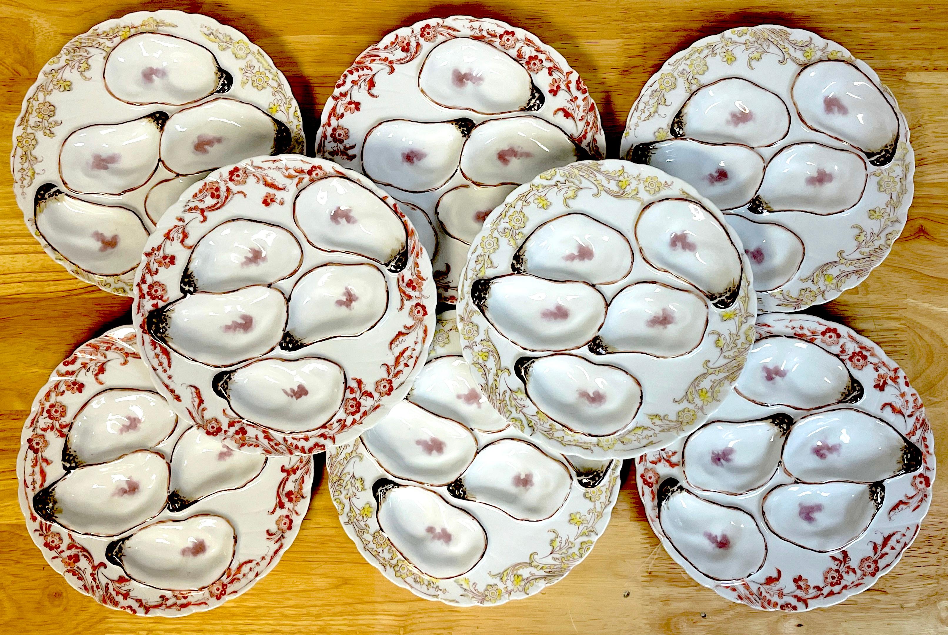 Eight 19th C Havilland Limoges Aesthetic Movement oyster plates, with four red floral and four yellow floral bordered five naturalistic oyster wells.