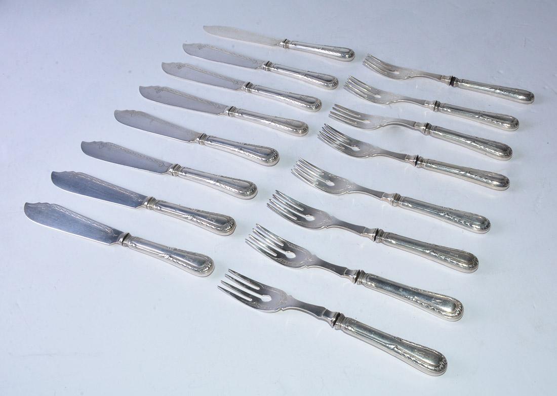 The eight fish forks and 8 fish knives set are 19th century French sterling (indicated by the engraved 800 number) were used when fish was served. The handles are embellished with classical beading, bay berries and leaves. The engraved initial is a