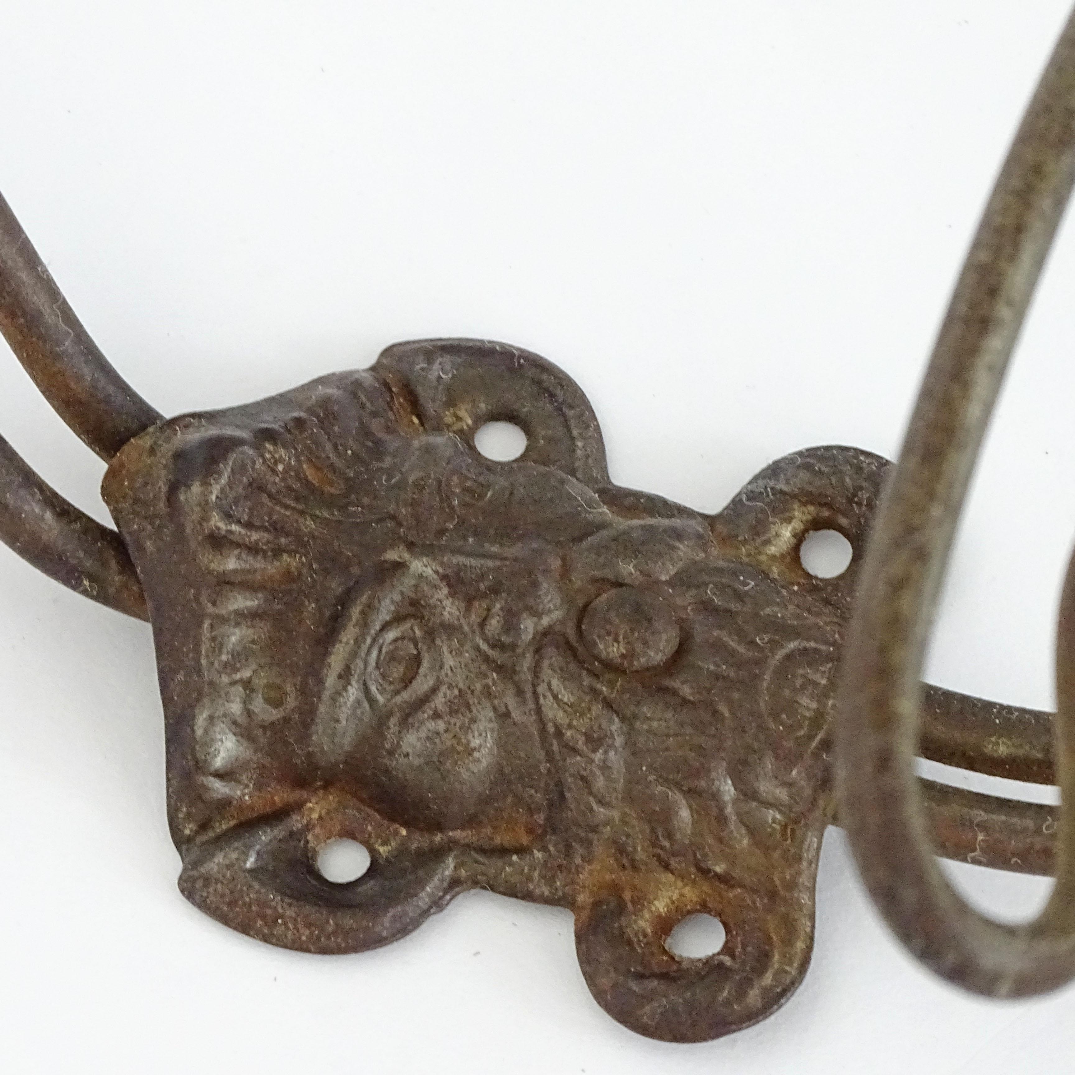Moorish Eight 19th Century Italian metal wall coat hangers with a classic male face. For Sale
