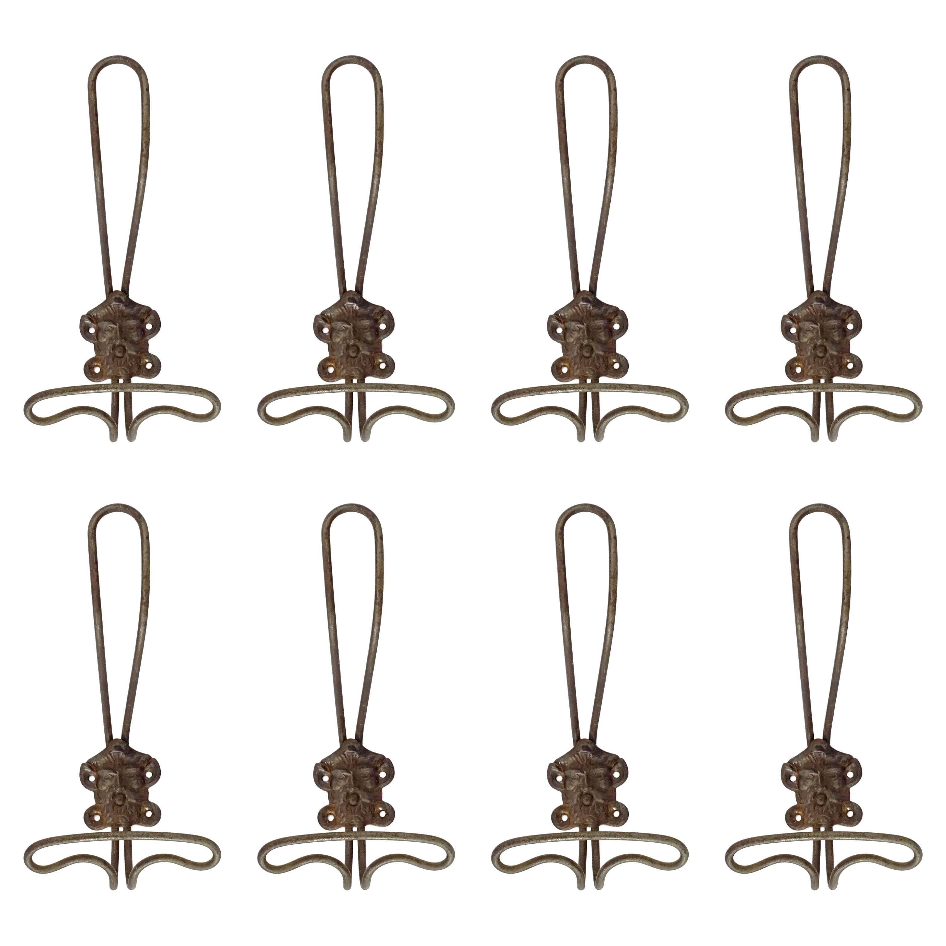 Eight 19th Century Italian metal wall coat hangers with a classic male face. For Sale