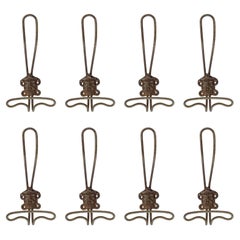 Eight 19th Century Italian metal wall coat hangers with a classic male face.