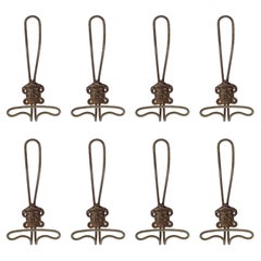 Antique Eight 19th Century Italian metal wall coat hangers with a classic male face.