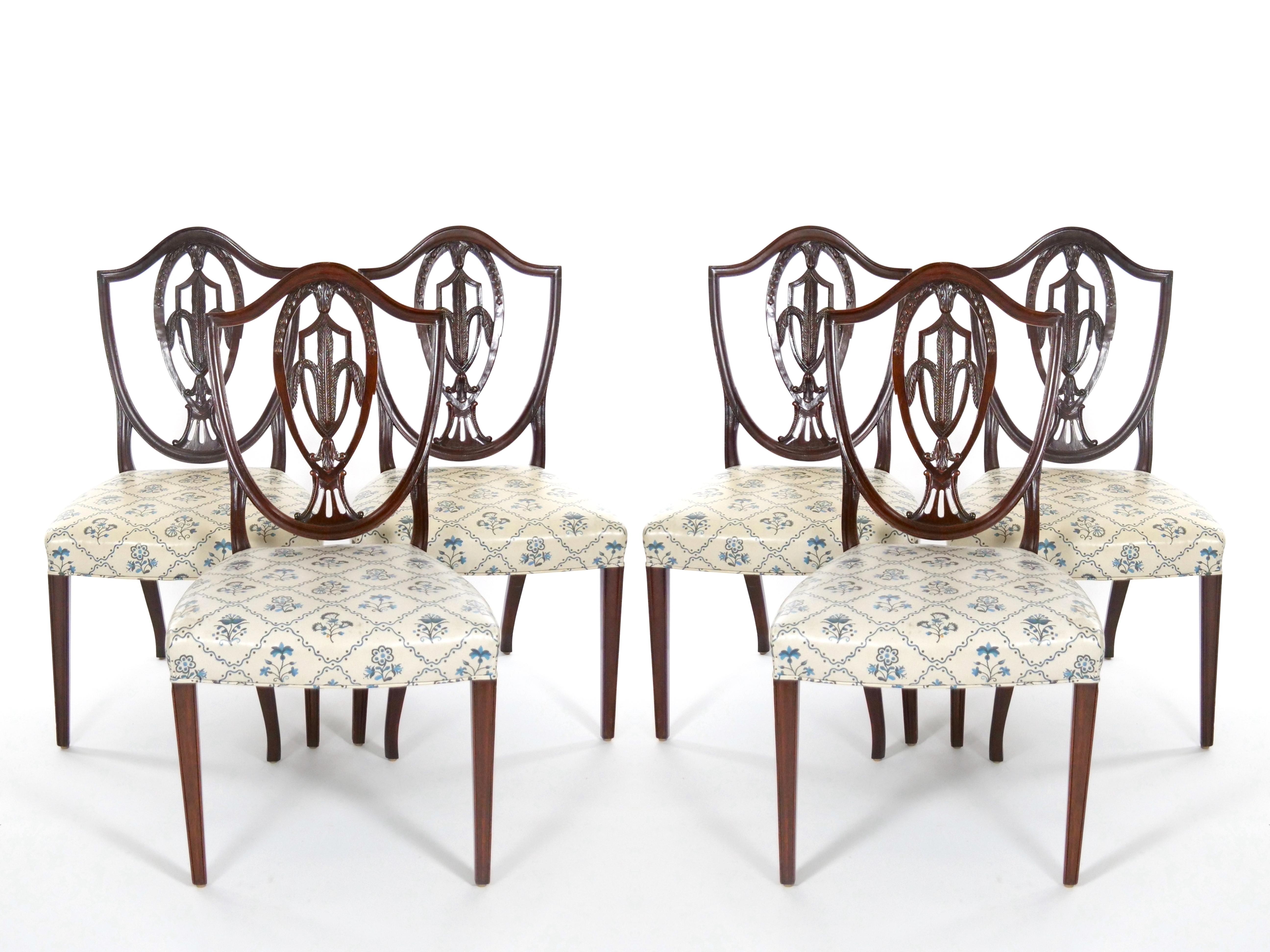 Presenting an exquisite set of antique Hepplewhite style dining chairs crafted from rich mahogany, showcasing the elegant Prince of Wales design. The set comprises two distinguished armchairs and six charming side chairs, each meticulously fashioned