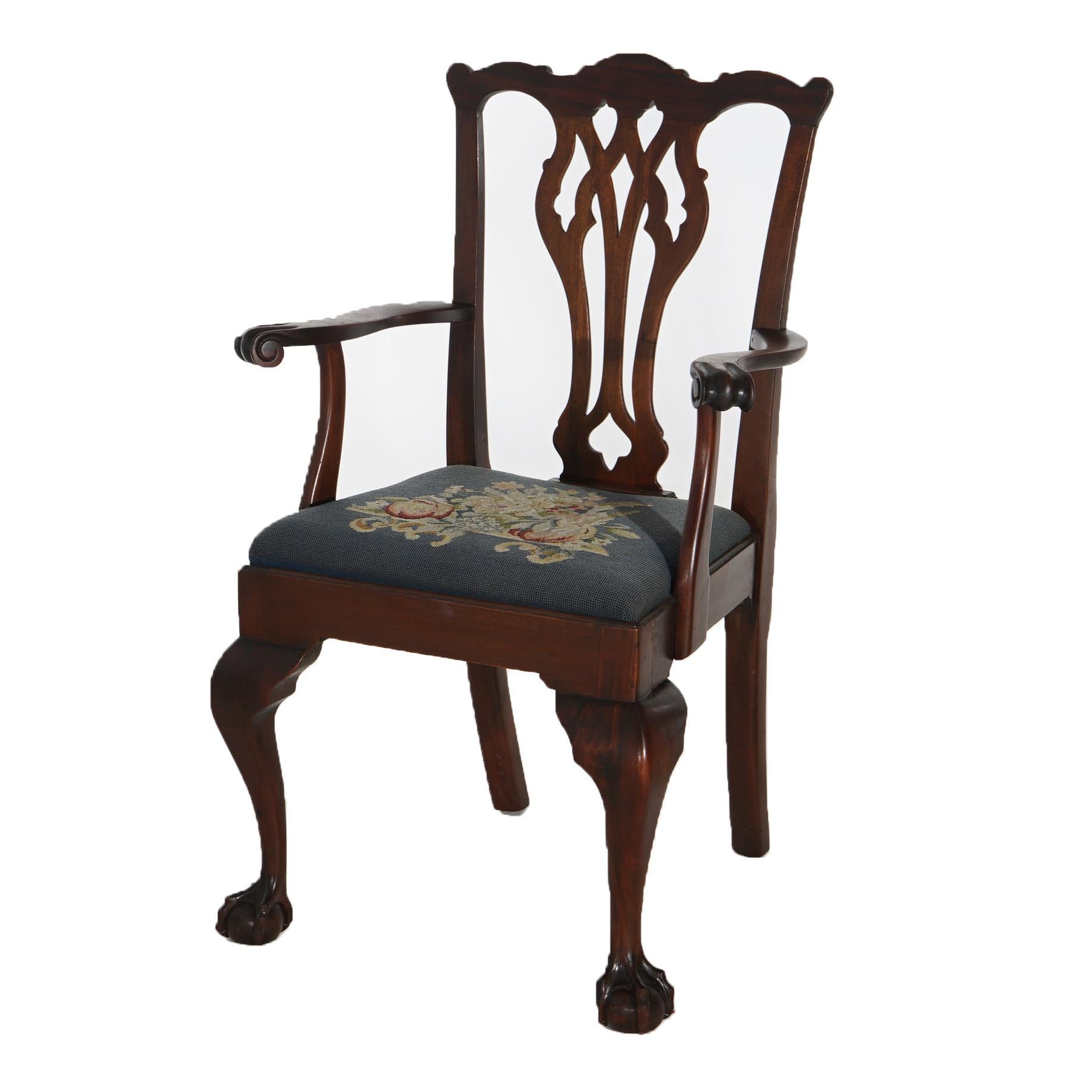 An antique set of eight Chippendale style dining chairs offers mahogany construction with shaped rail over pierced slat back, needlepoint upholstered seats and raised on cabriole legs terminating in claw and ball feet, c1920

Measure - 38.75