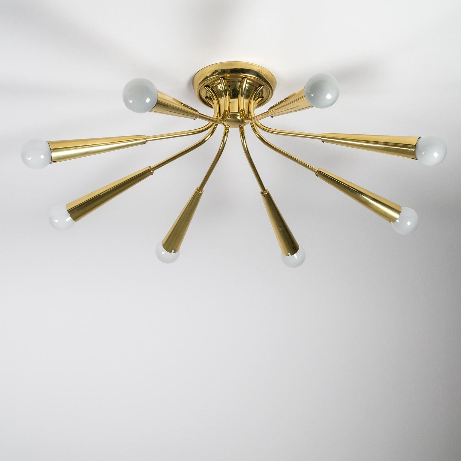 Elegant eight-arm brass sputnik flush mount from Germany, 1960s. Perfectly suited for low ceiling environments that require a high light output. Very good original condition with just a touch of patina. Each arm has one original brass E14 socket
