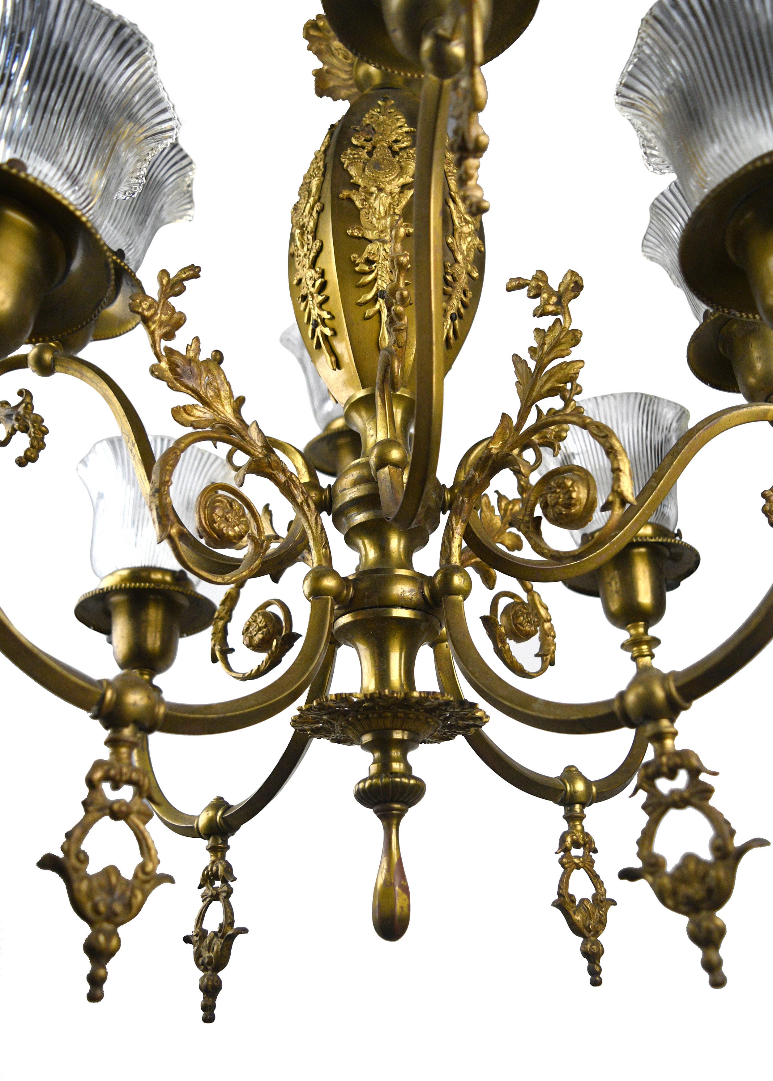 This stunning brass gas/electric chandelier features intricate floral details and a handsomely crafted winding brass design. The eight lights of this chandelier give off ample illumination!

Circa: 1910
Condition: Very good 
Finish: