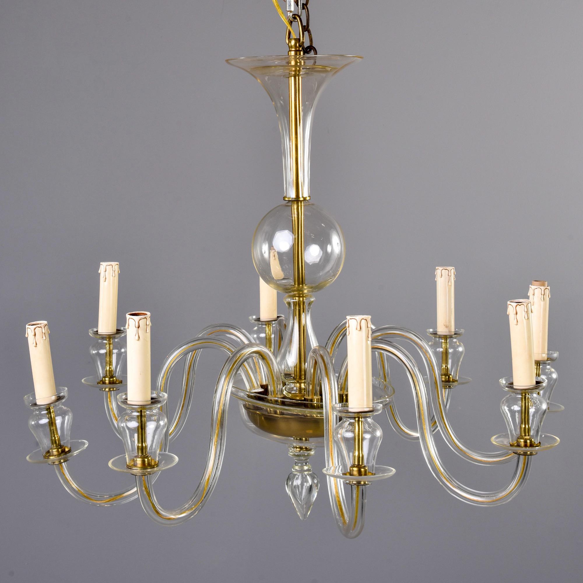 Murano chandelier in pale amber glass with eight arms and candle style lights with candelabrum sized sockets, circa 1960s. New wiring for US electrical standards. No flaws found. Unknown Murano maker.