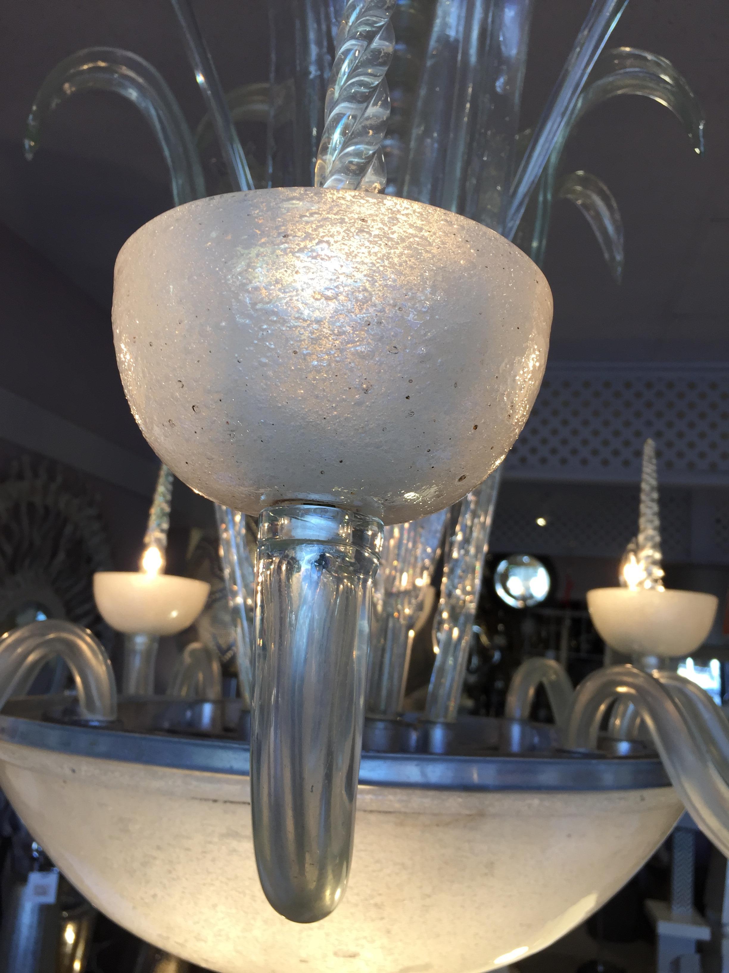 Exceptional 1930 blown frosted and transparent white glass Murano chandelier.
Eight arms (maximum 60 watts each one .Candle base)
Plus the under magnificent frosted glass bowl (3 center lights 60 watts each)
The white frosted glass chandelier is