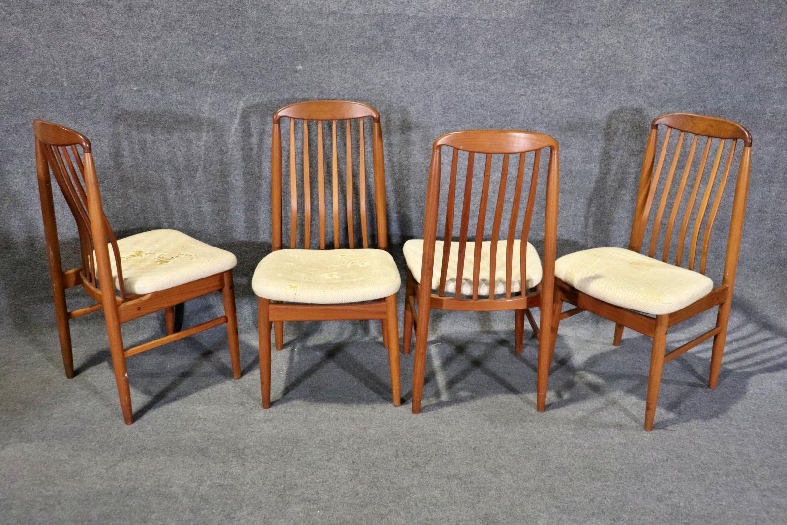 Set of eight Danish style dining chairs by Benny Linden. Soft teak frames with slat backs and foam cushions. Two arm chairs, six side chairs.
2 arm chairs measure 38 1/4