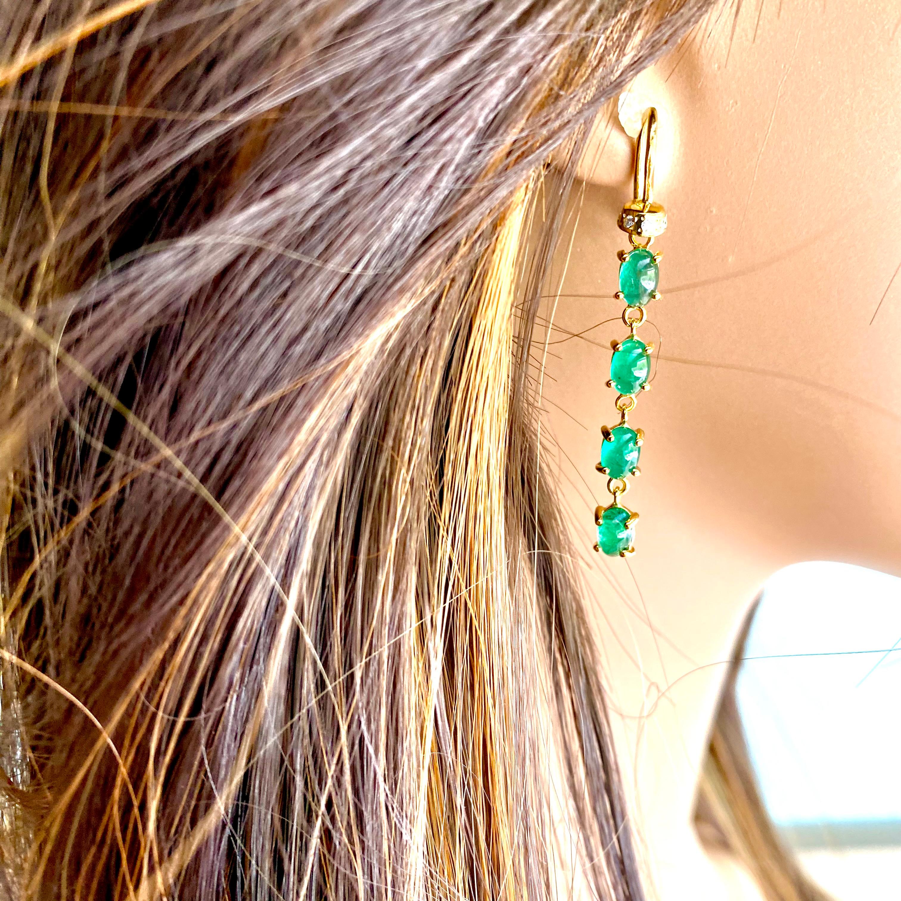 Cabochon Emerald and Diamond Yellow Gold Hoop Drop Earrings are a luxurious piece of jewelry that is designed to enhance any formal or casual outfit, measuring 1.50 inch long.
The earrings feature a sleek 14 karat yellow gold hoop that dangles from