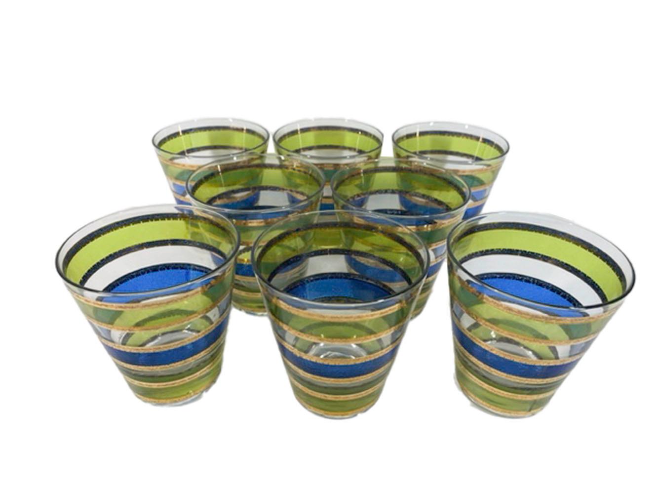 Eight vintage double old fashioned glasses by Culver, LTD. in the Rondo pattern. Decorated with a band of translucent blue enamel between bands of translucent green enamel and with the bands having borders of 22k gold with irregular edges and raised