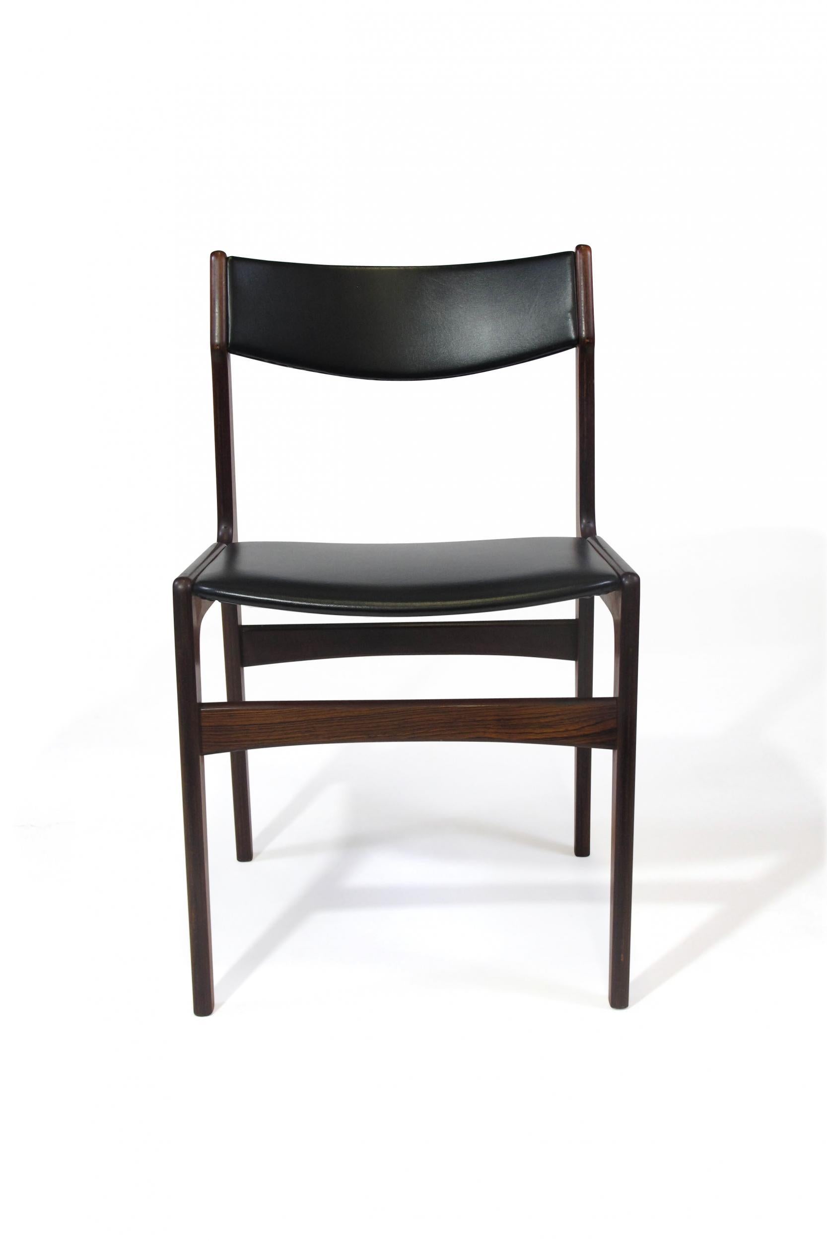 Eight Brazilian rosewood dining chairs attributed to Erik Buch, circa 1965, Denmark. Features a rosewood frame with comfortable slightly angled backrests. Upholstered in the original black vinyl. The chairs have been lightly cleaned and oiled,