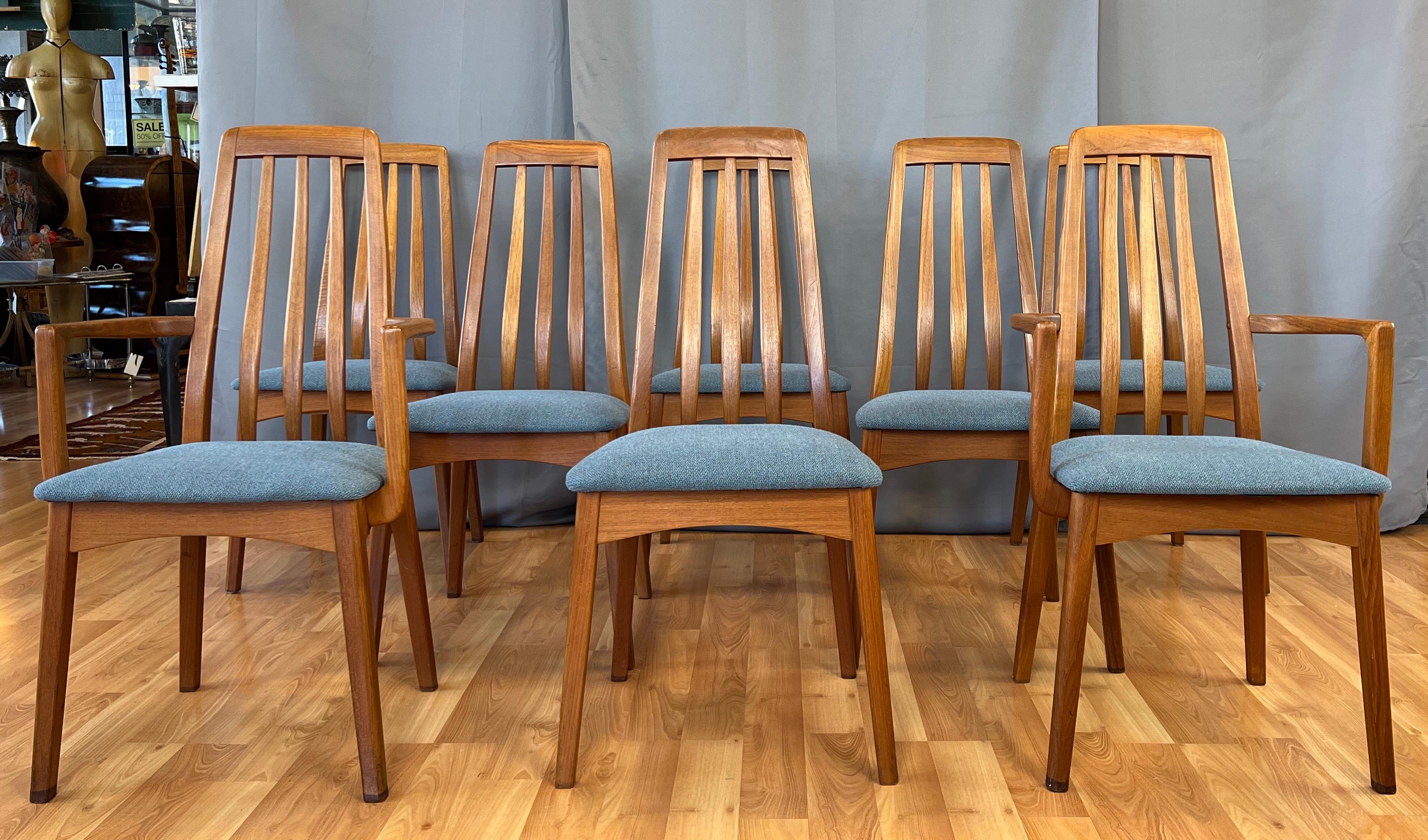 Nice large eight piece high-back set, a rail-back design. Teak dining chairs by Benny Linden, Danish Modern in style.
Two captain chairs, and six side chairs, all have the same blueish green upholstery that feels to be a blend.
With their curved