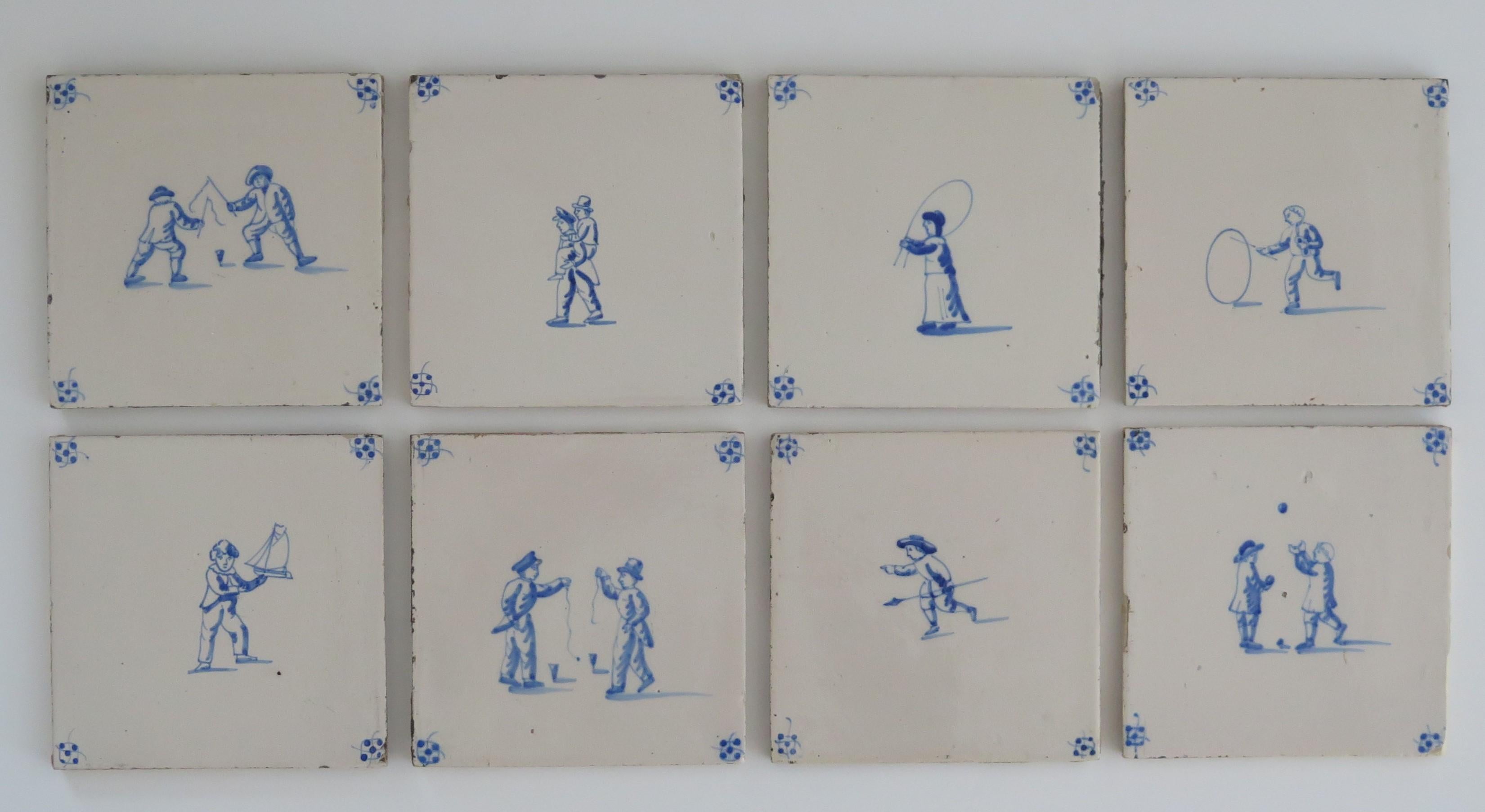 These are a set of eight Delft wall tiles, all with hand painted blue and white scenes of Children playing different games, made in the Netherlands during the 19th century.

The tiles are ceramic, made of earthenware pottery and nominally about