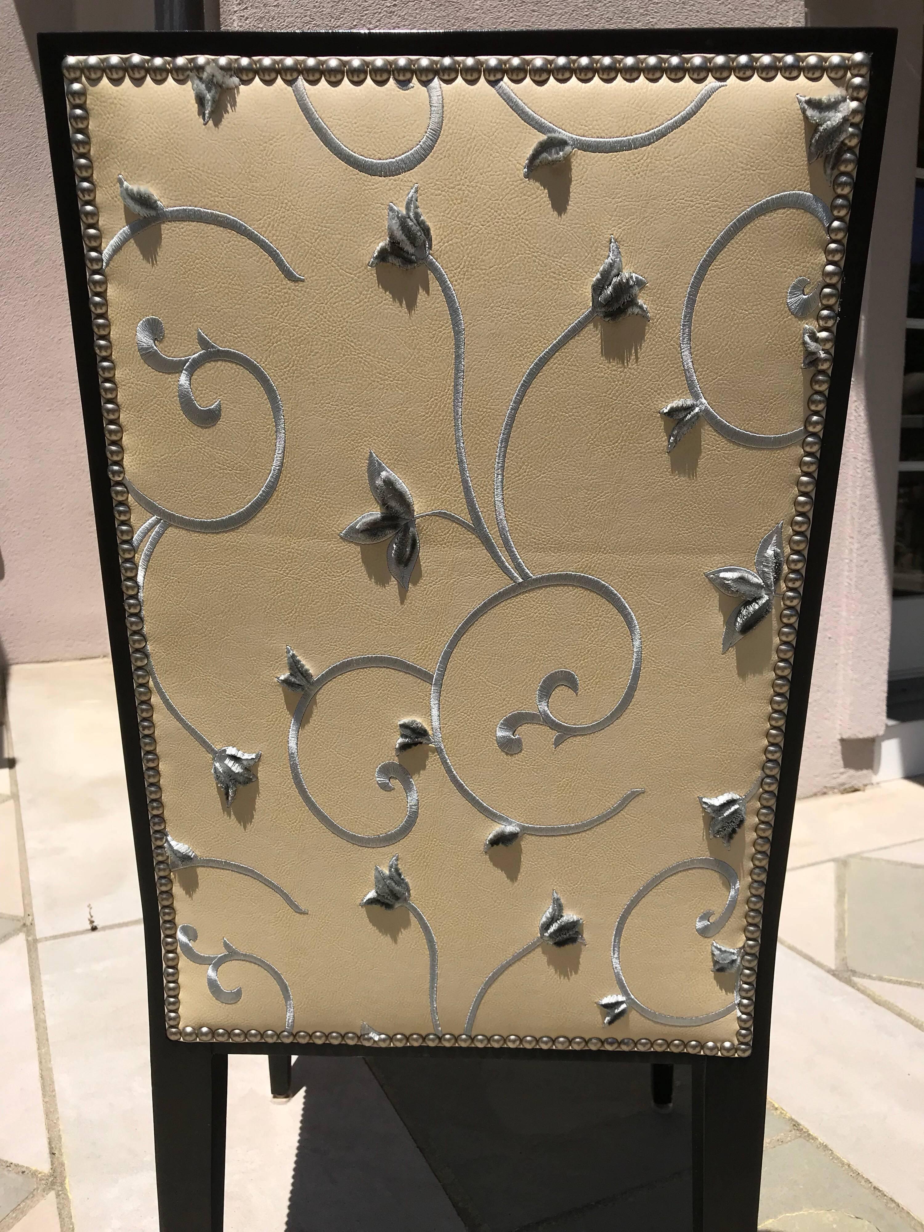 Eight beautifully upholstered Mid-Century Modern style dining chairs by Artistic Frame.
The upholstery on the inside back and seat are made of leather Shagreen. (SH94) The backsides are covered in embroidered leather by Zimmer & Rhode Anita
