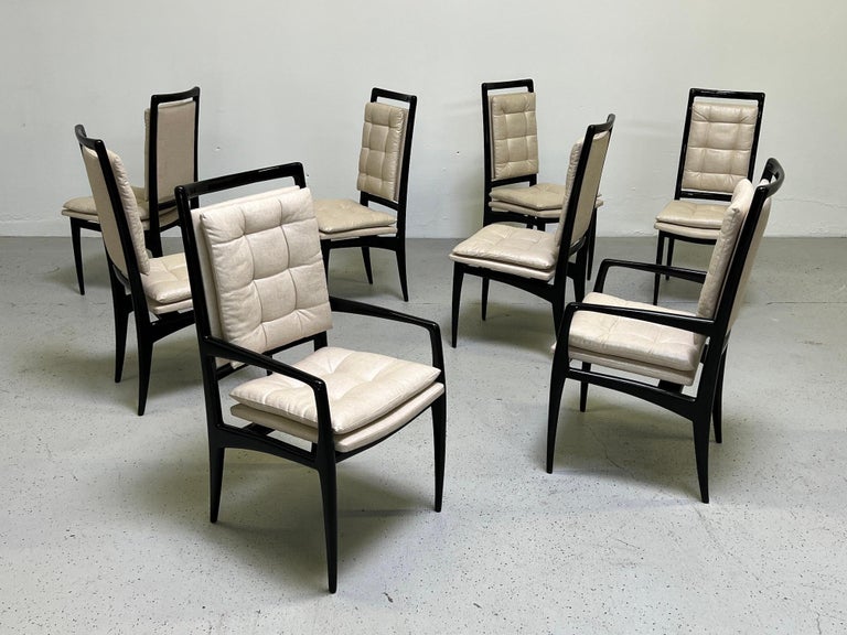 A set of eight dining chairs in black lacquer and raw silk designed by Vladimir Kagan.