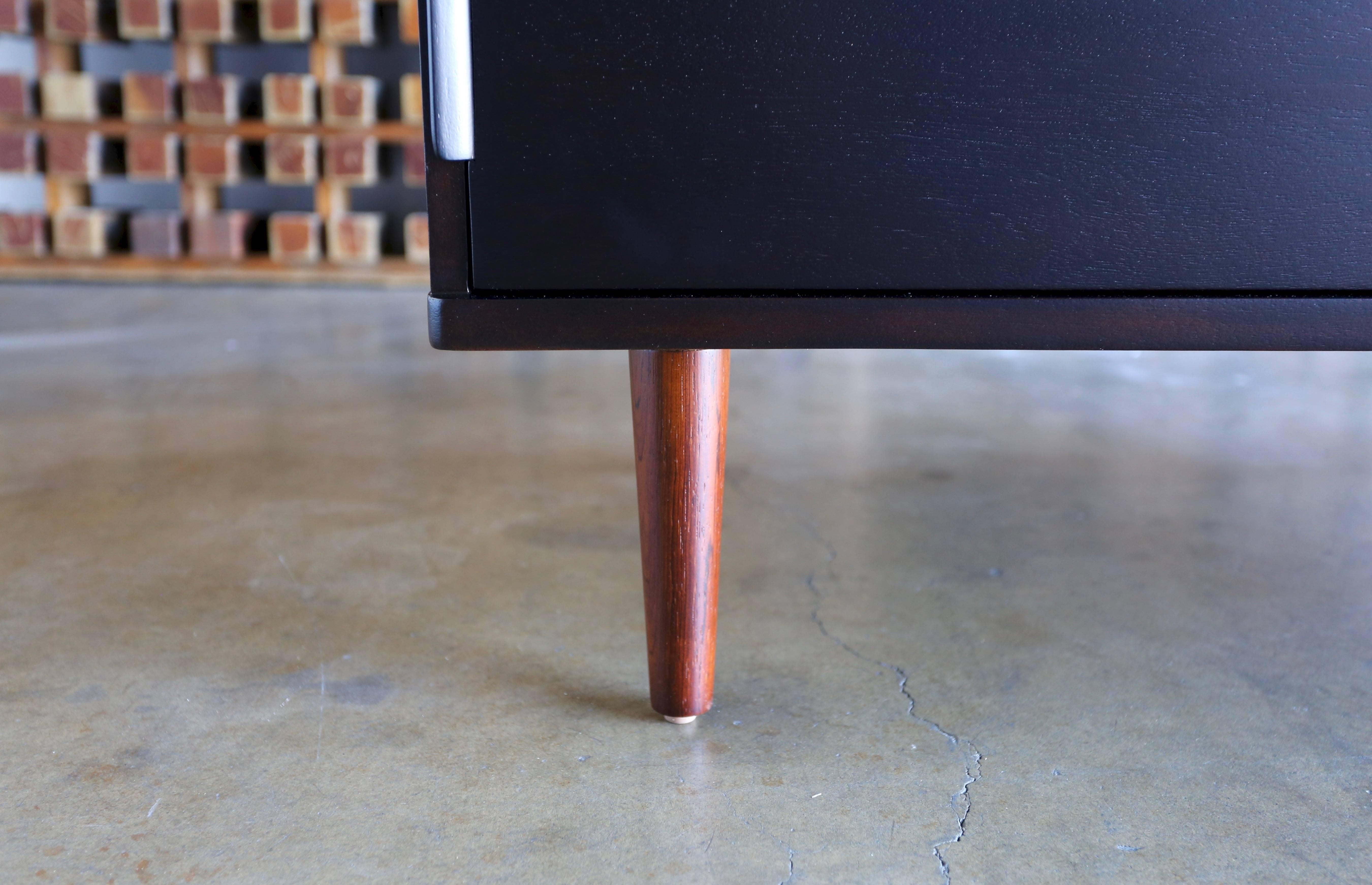 Ebonized eight-drawer chest with rosewood legs by Edward Wormley for Dunbar. This piece has been professionally restored. 

 