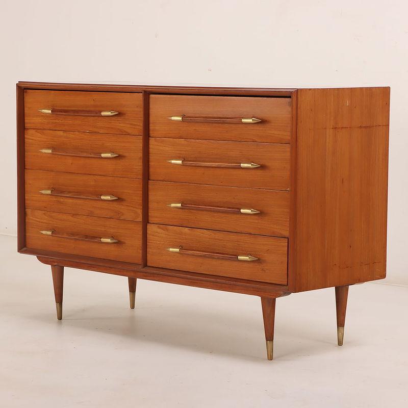 Elegant 8-drawer dresser or sideboard in the style of T.H. Robsjohn-Gibbings. The piece features eight solid oak drawers, each fitted with elongated, sculpted handles accented in gold. Versatile and refined, it serves beautifully as a statement