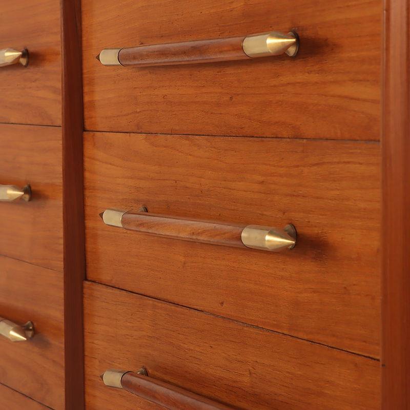 20th Century Eight drawer dresser with elongated wood and brass handles For Sale