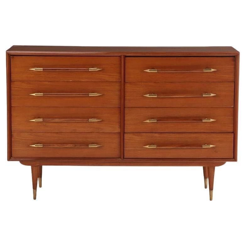 Eight drawer dresser with elongated wood and brass handles For Sale