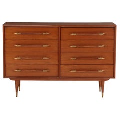 Eight drawer dresser with elongated wood and brass handles