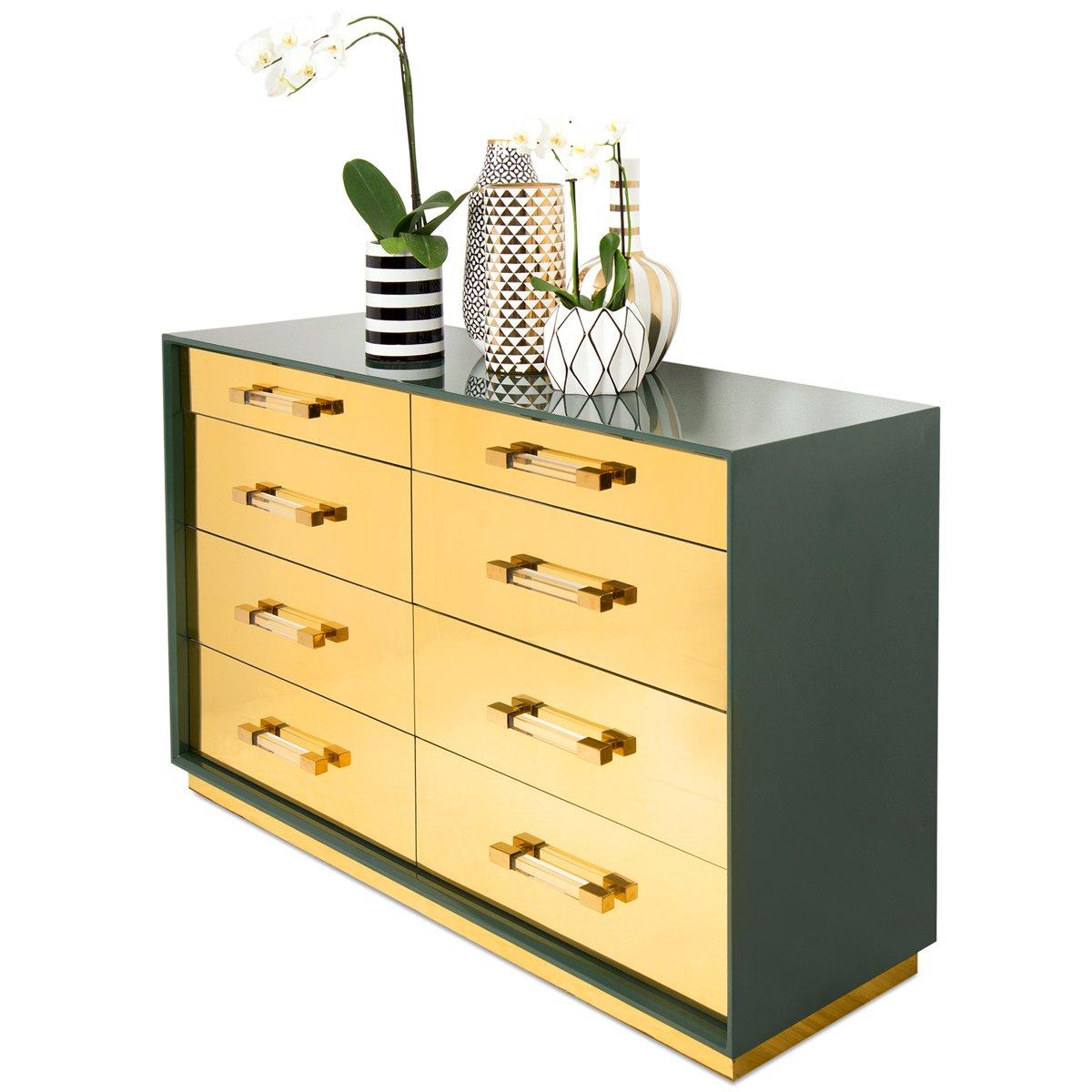 Introducing the Mauritius dresser. This tall dresser features plenty of storage with eight drawers and plenty of style with shiny brass veneer drawers, a glossy Hunter Green finish, Lucite and shiny brass bar pulls, and a shiny brass toe kick. With
