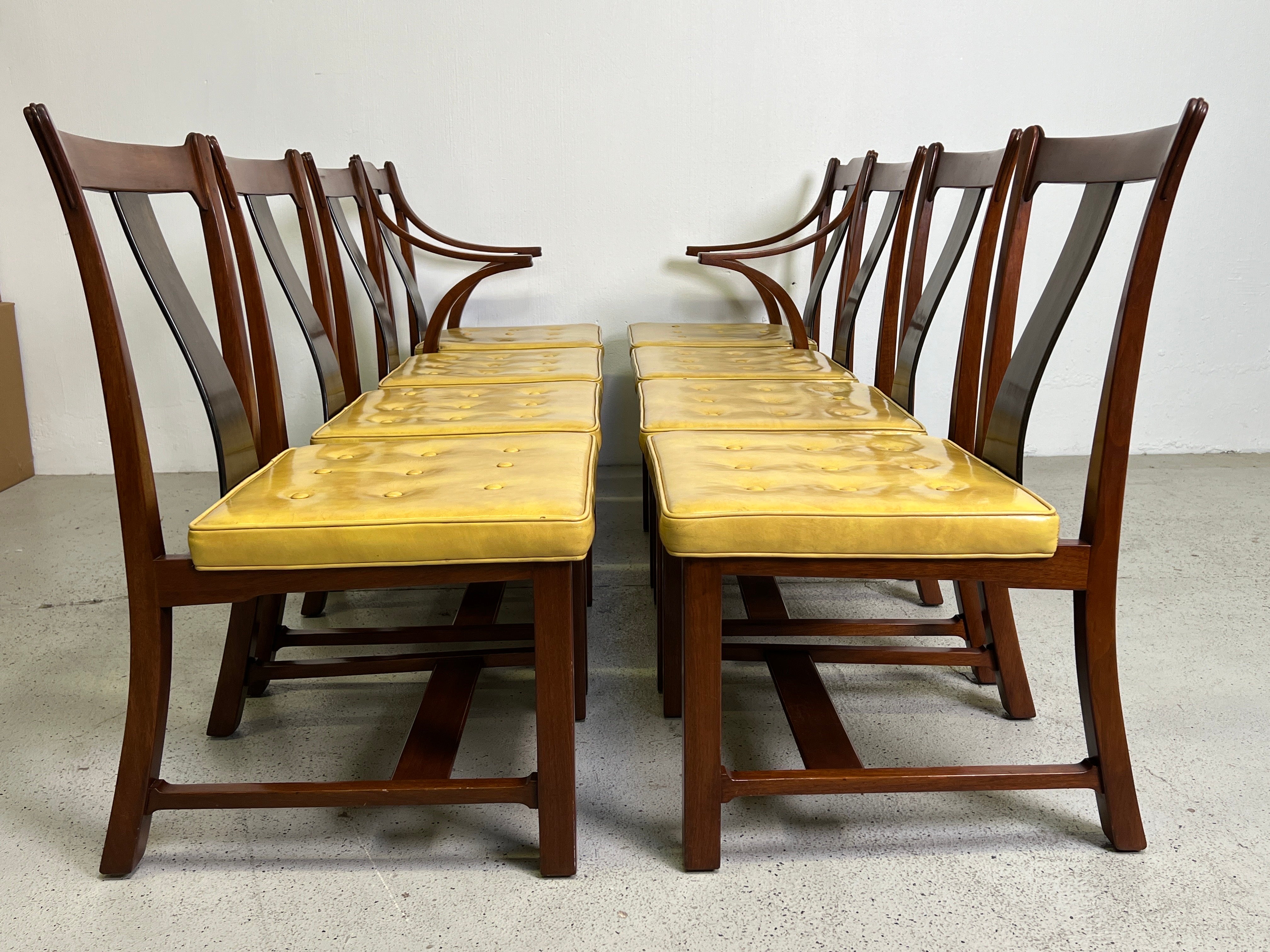 A rare set of eight dining chairs designed by Edward Wormley for Dunbar. Known as the Greene & Greene chair for it's crafted look with exposed tenon crest rail, rosewood bowed center splat and solid walnut construction. These chairs were only in
