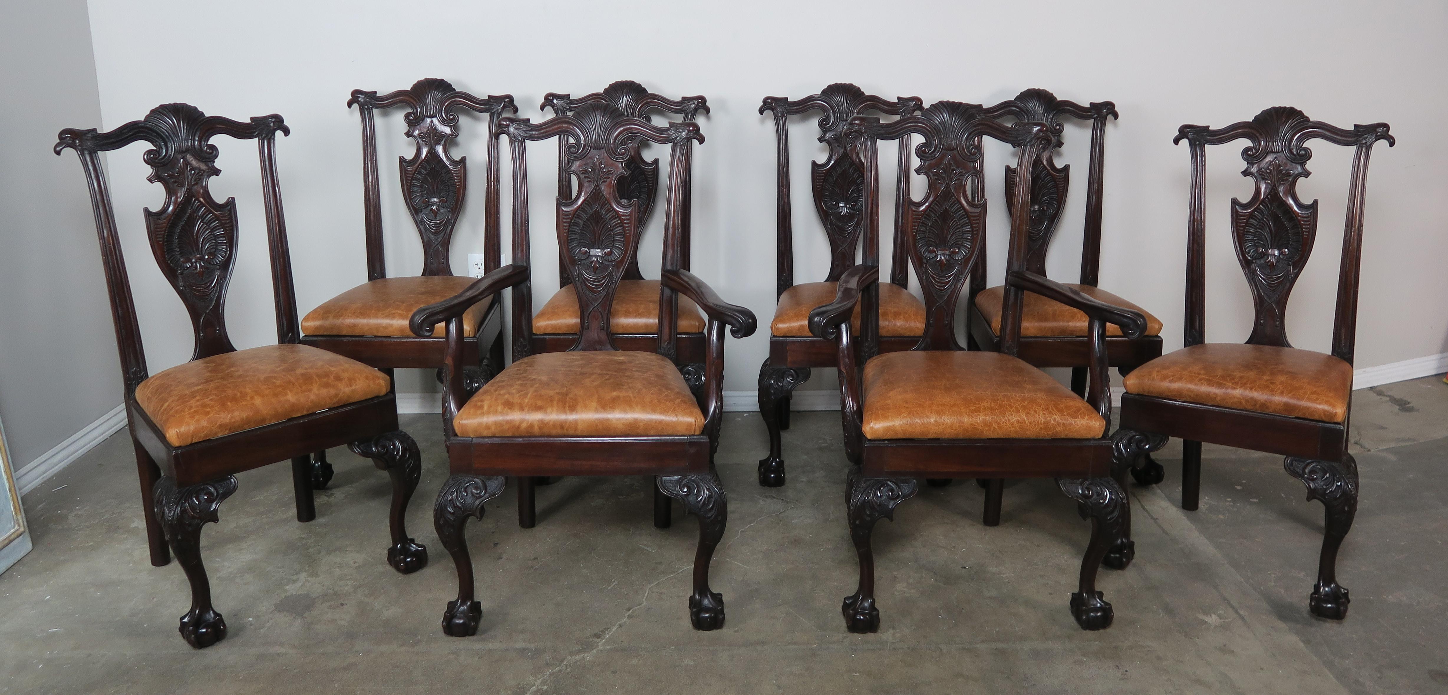 Set of eight English walnut carved Chippendale style dining chairs with intricate carvings of eagles, acanthus leaves, claw and ball feet, and so much more. The seats are upholstered in a honey colored brown leather.
Armchairs size: 29 x 21 x 41